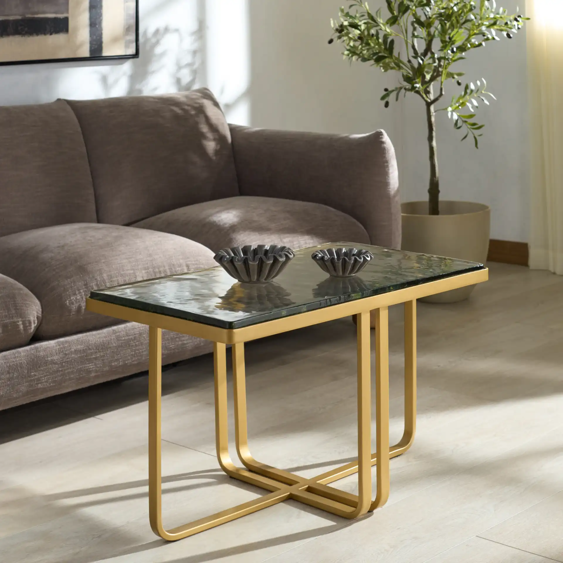 Dominic Glass Top Coffee Table in Brass / Clear in a styled room