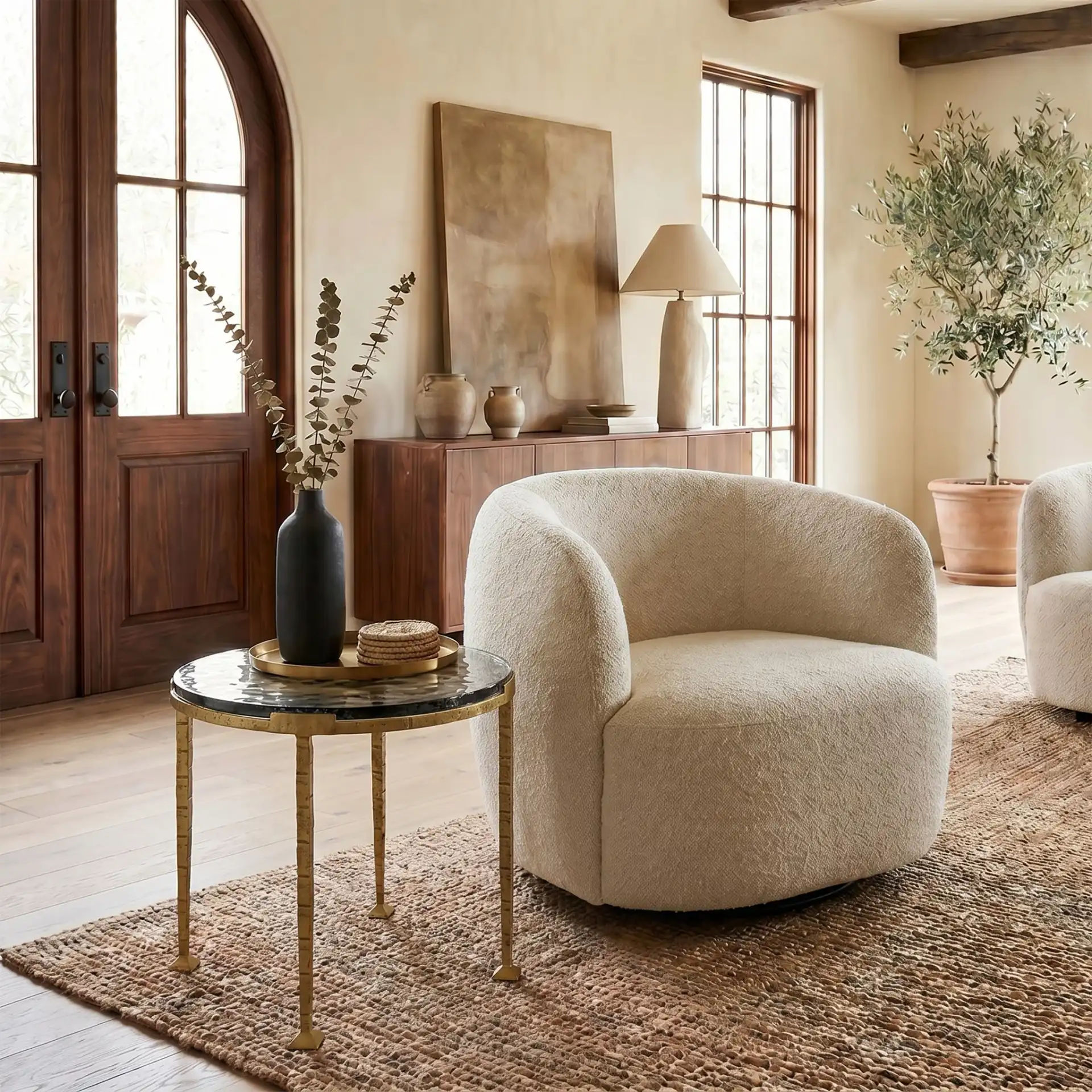 Karmelina Round Accent Table in Smoked Glass / Brass in a styled room