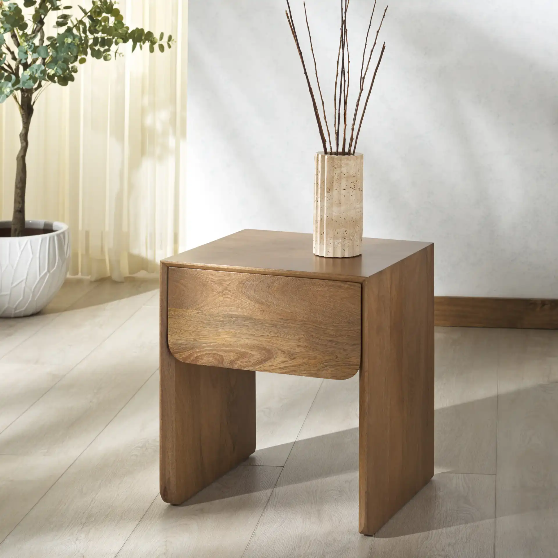 Grigorio One-Drawer Nightstand in Brown in a styled room