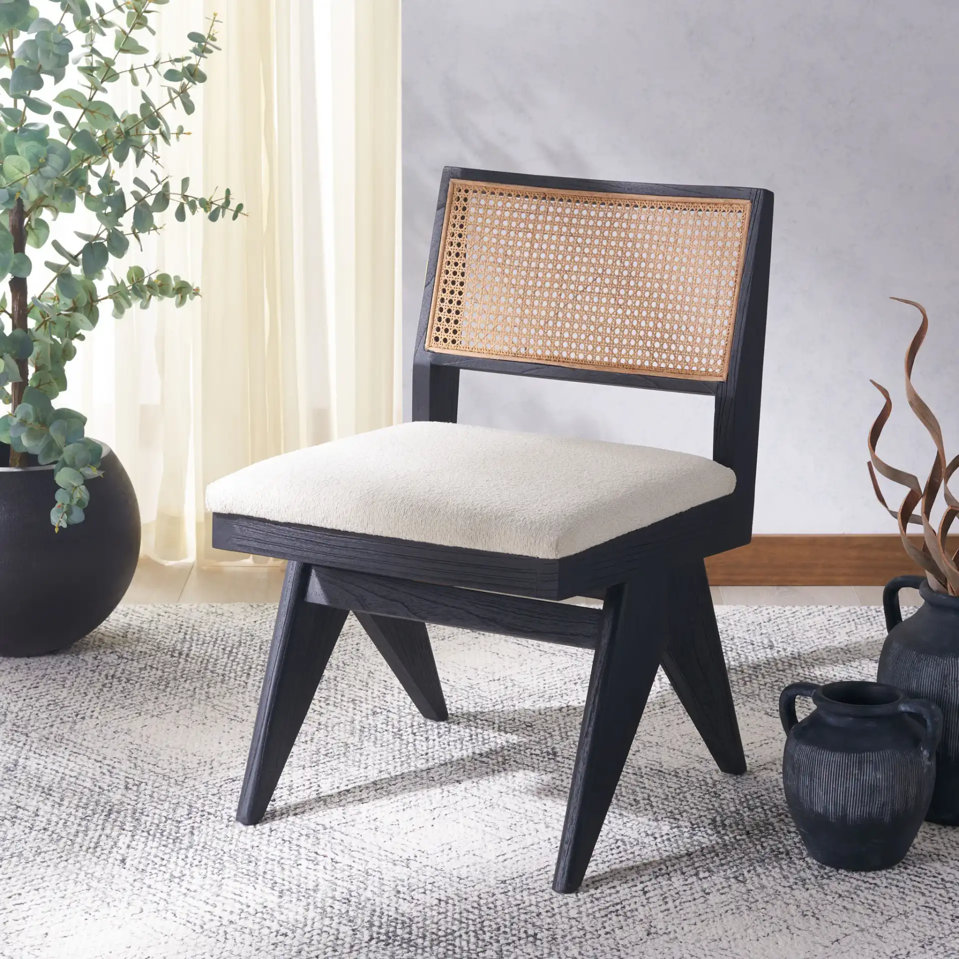 Jaqueline Rattan Back Chair in Beige / Black in a styled room