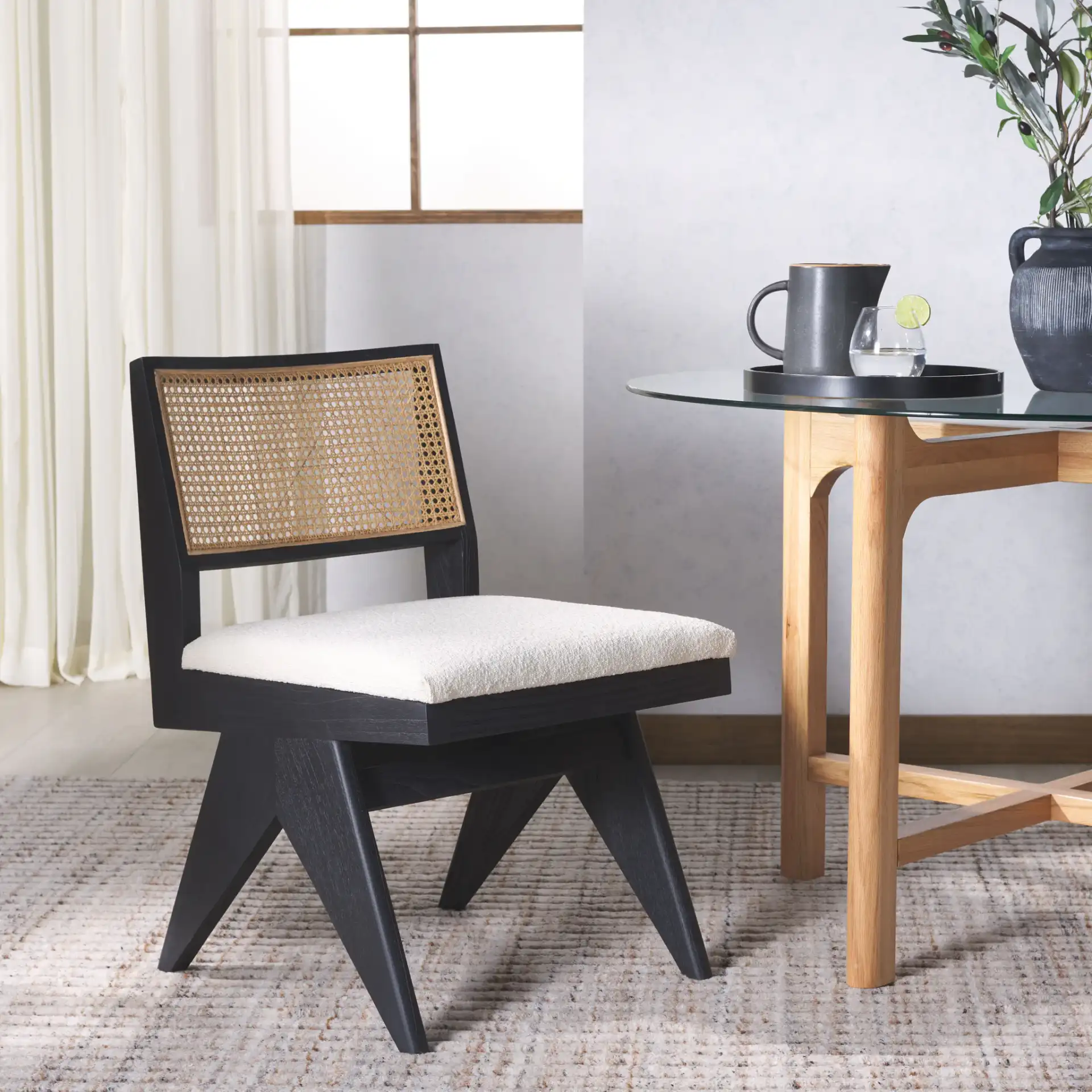 Jaqueline Rattan Back Chair in Beige / Black in a styled room