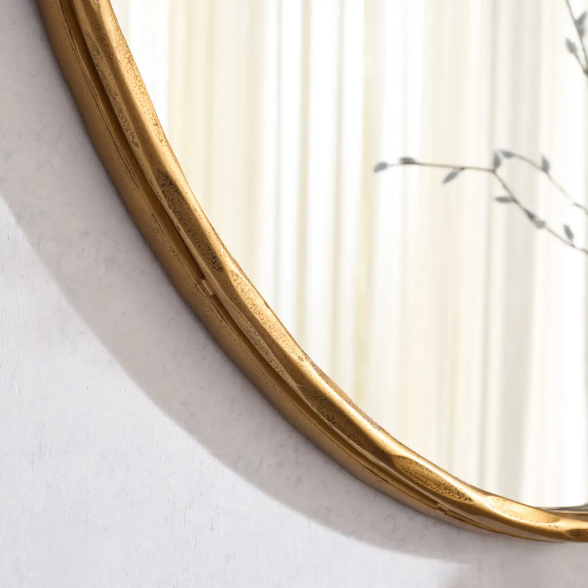 Jessa Oval Metal Mirror in Brass in a styled room