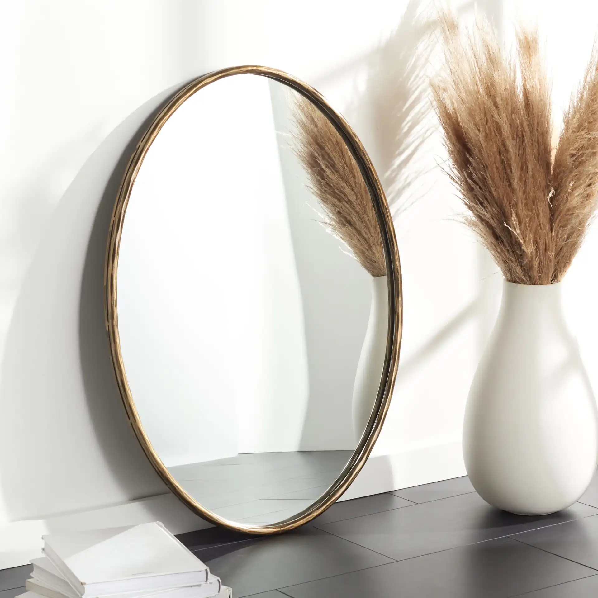 Jessa Oval Metal Mirror in Brass in a styled room