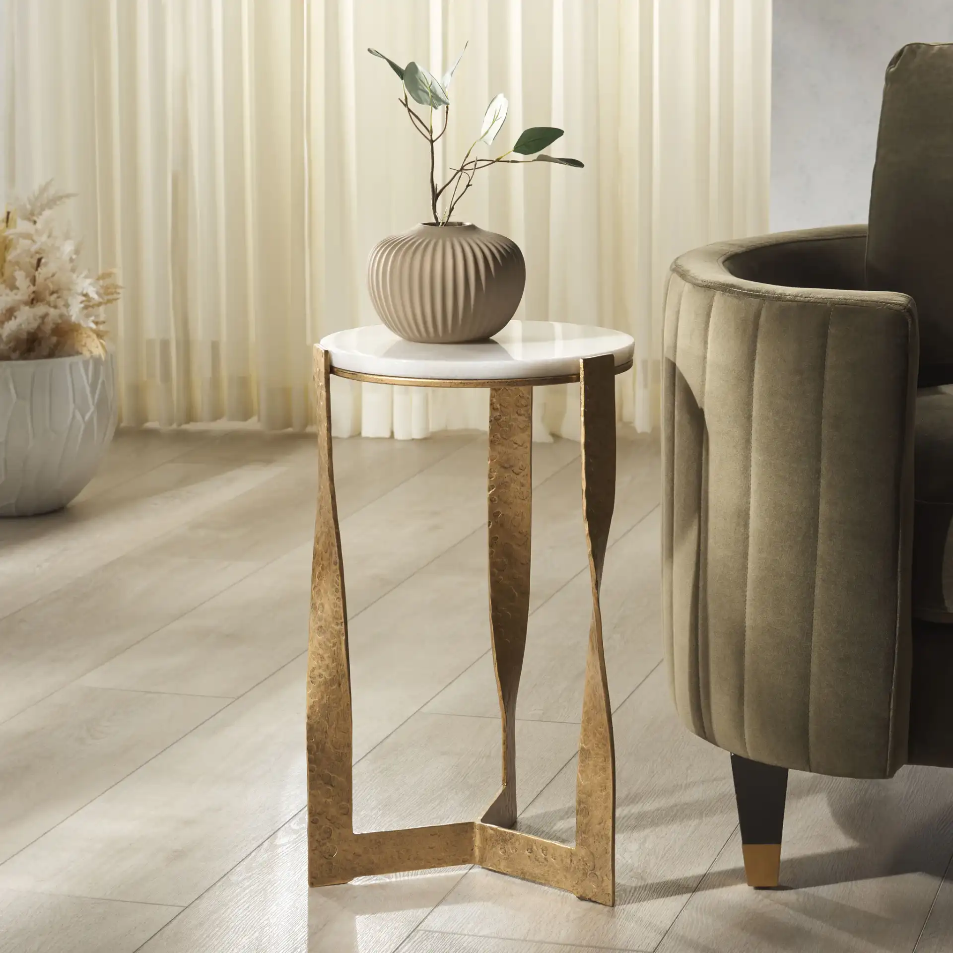 Raynie Metal Accent Table in Brass / White in a styled room