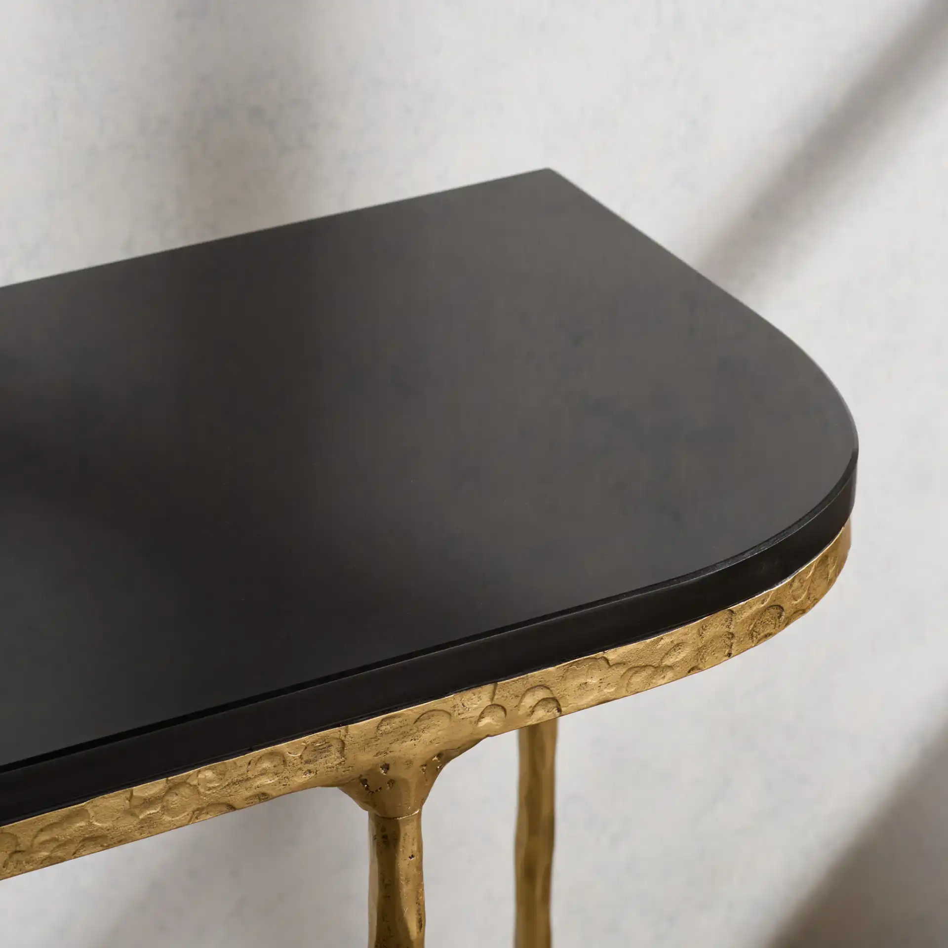 Janowsky Metal Console Table in Brass / Black in a styled room