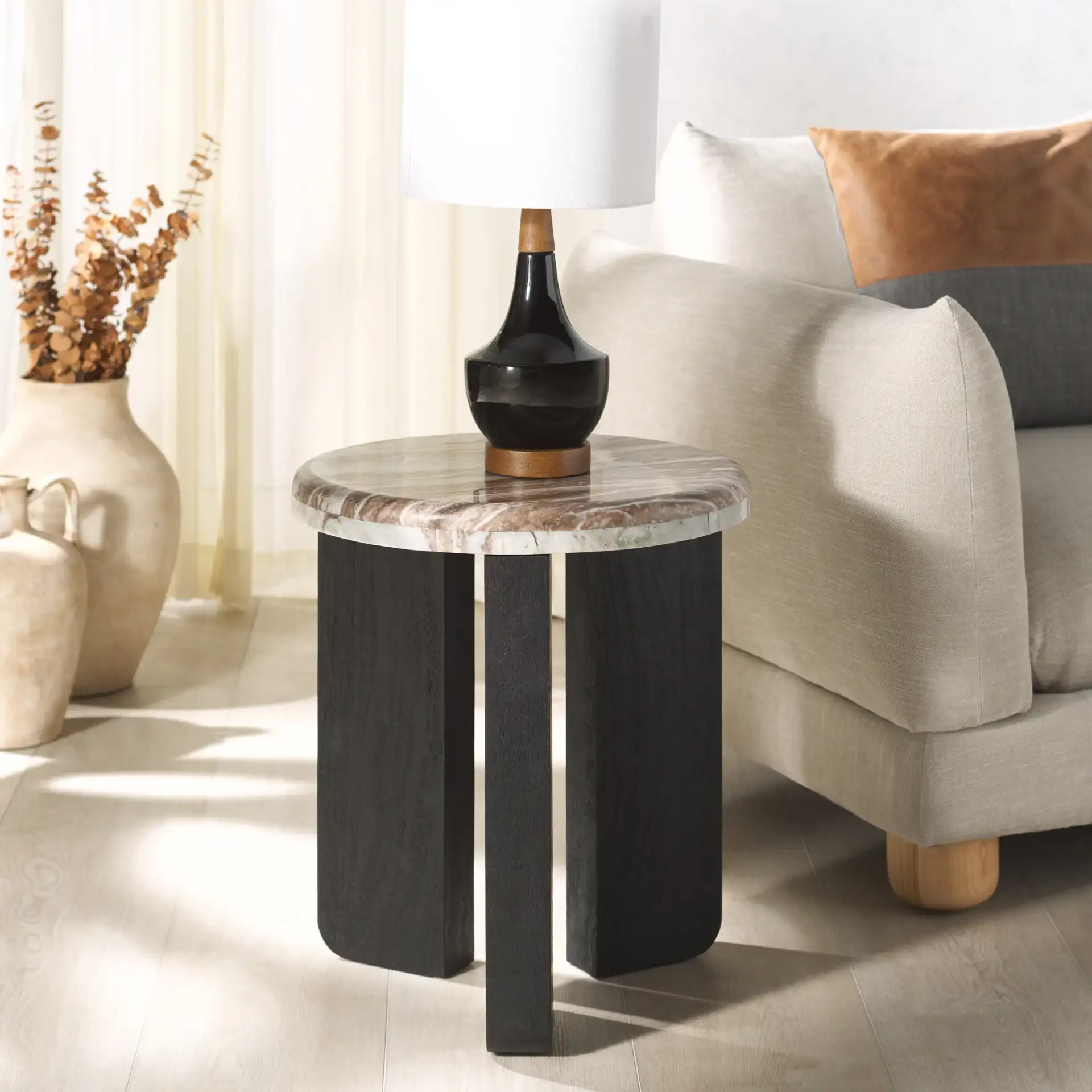 Malkin Round Marble Accent Table in Brown / Dark Brown in a styled room