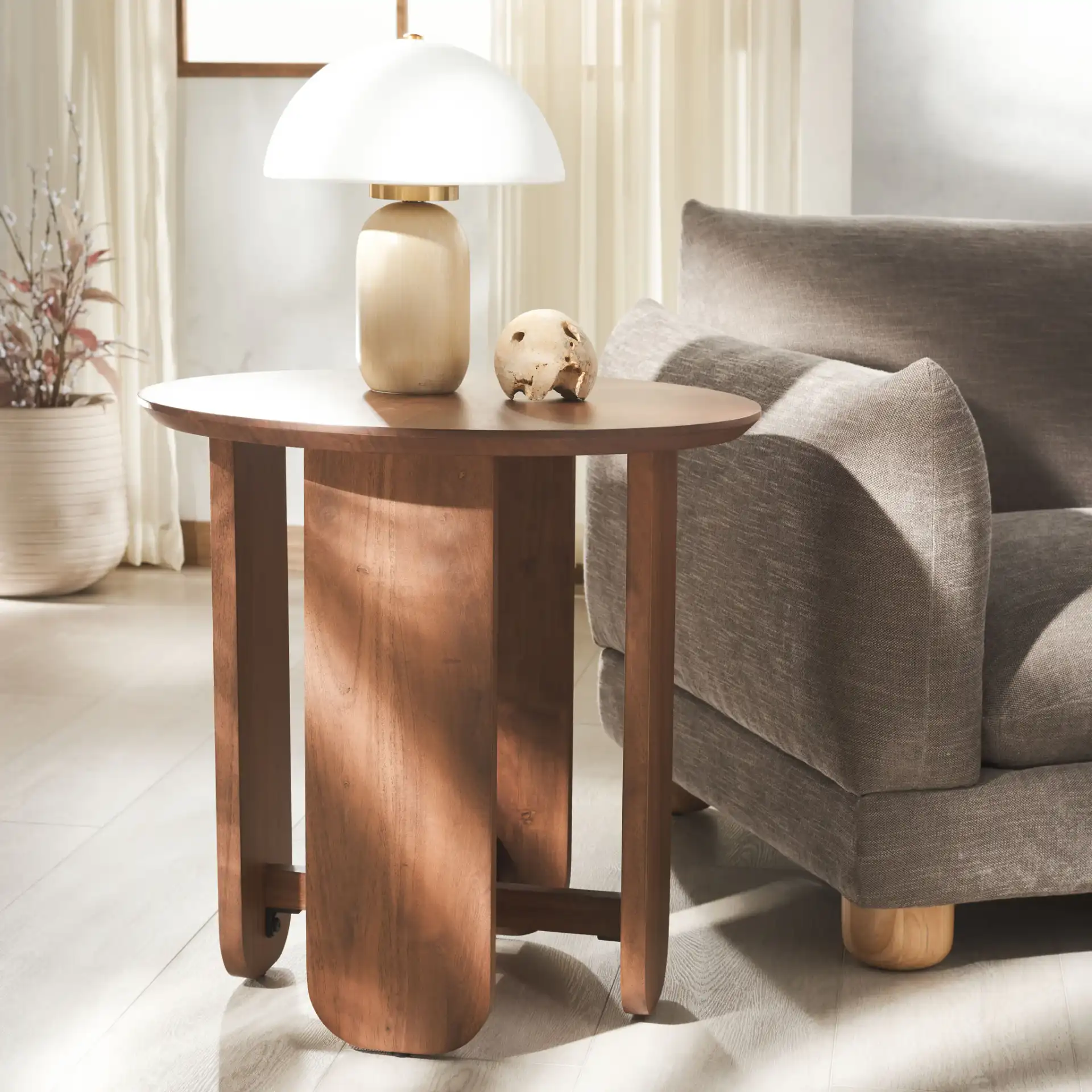 Raybelina Round Accent Table in Walnut in a styled room