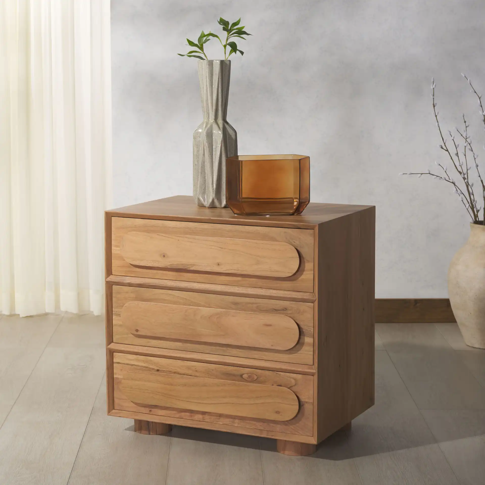 Lesliette Three-Drawer Nightstand in Natural in a styled room