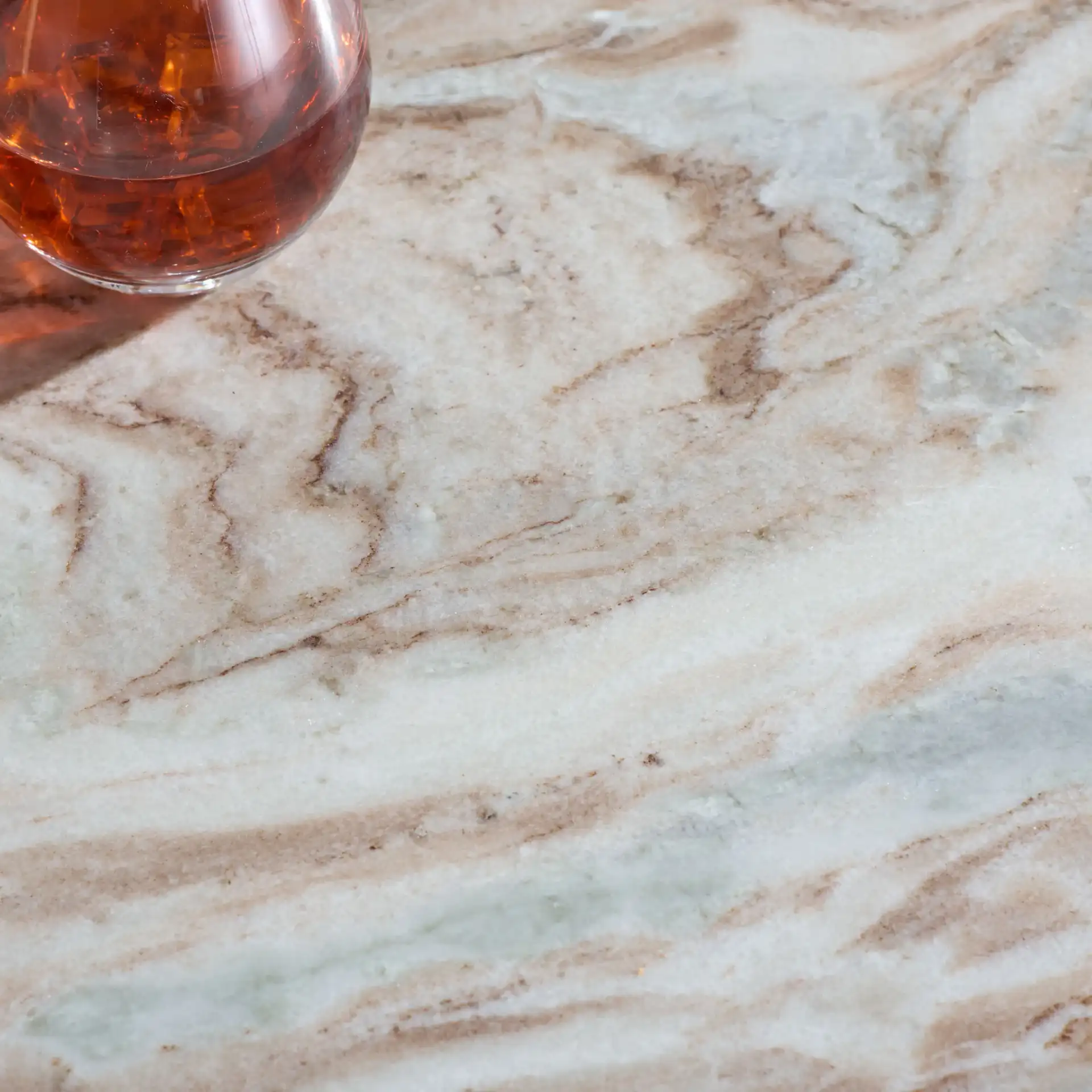 Bindi 3 Leg Marble Dining Table in White / Brown in a styled room
