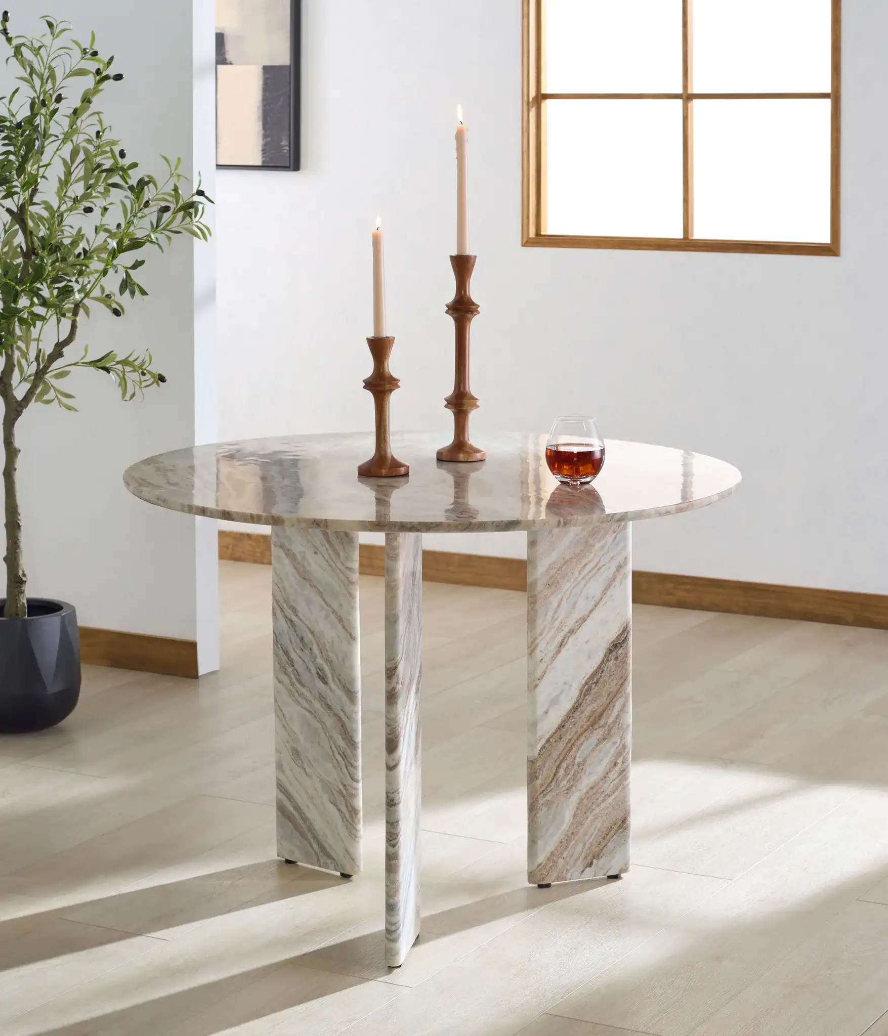 Bindi 3 Leg Marble Dining Table in White / Brown in a styled room
