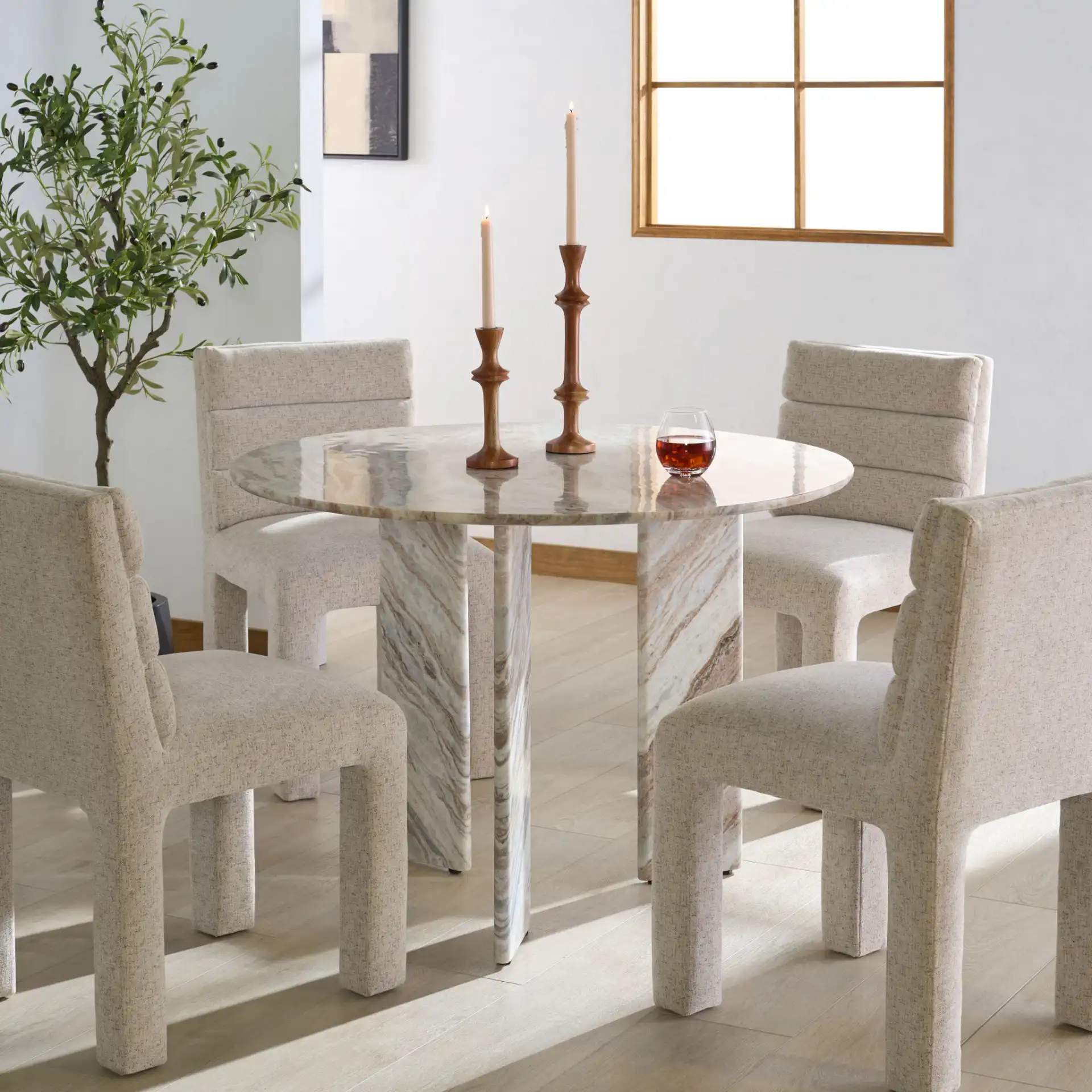 Bindi 3 Leg Marble Dining Table in White / Brown in a styled room