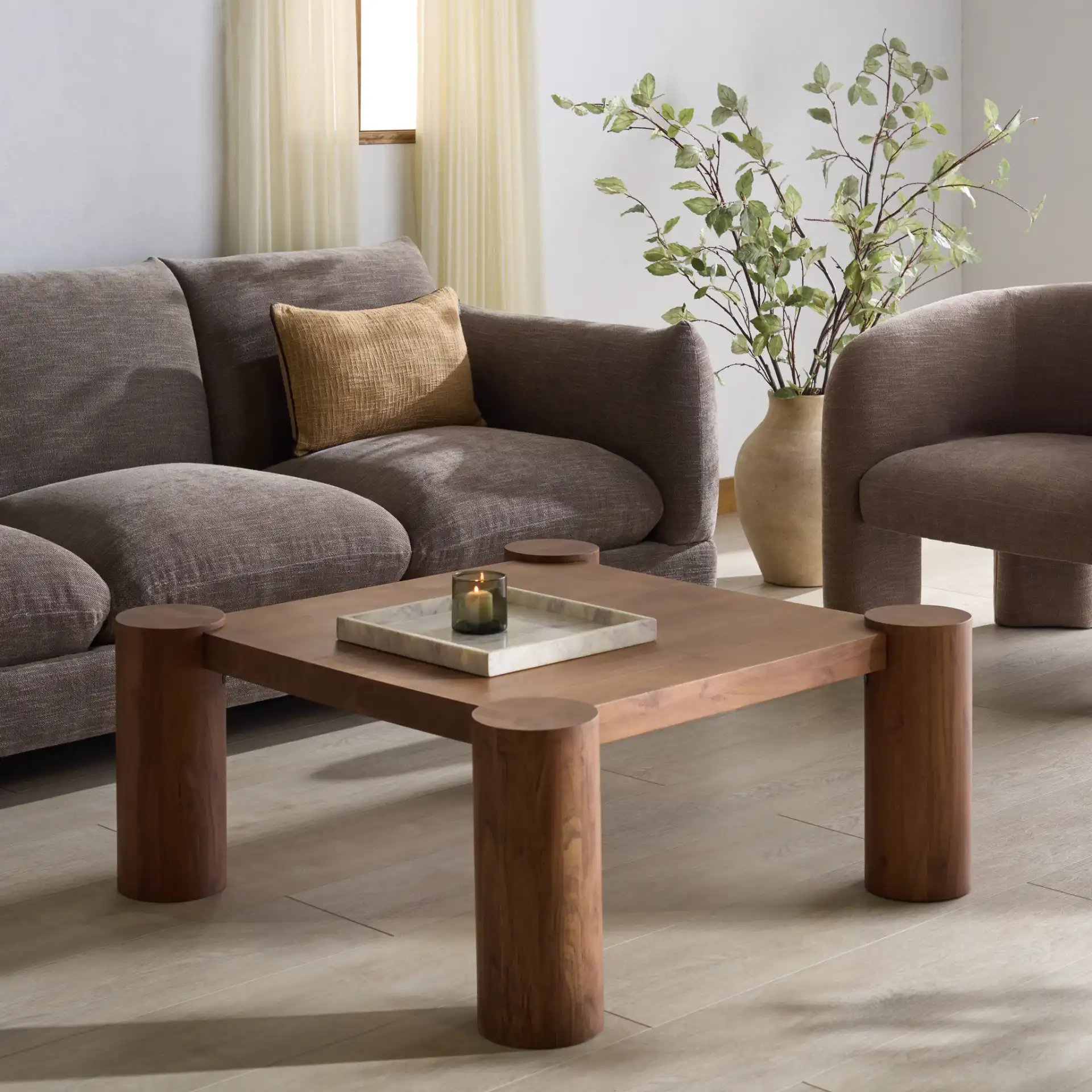 Trescott Square Wood Coffee Table in Natural in a styled room