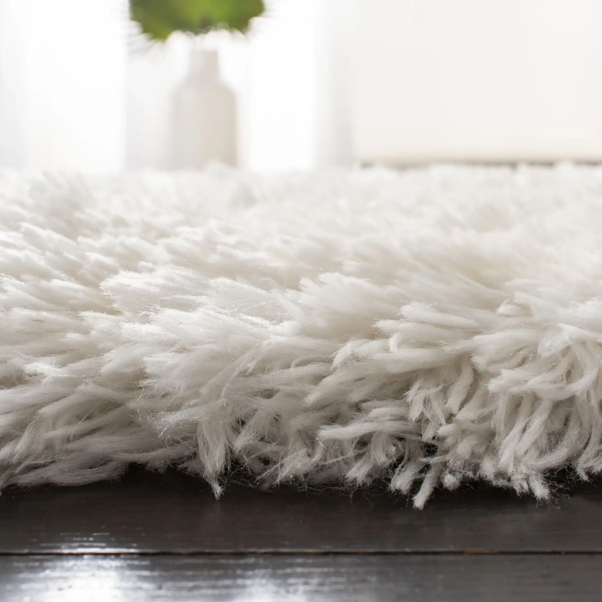Arctic Solid Hand-Tufted Shag Rug in Ivory in a styled room