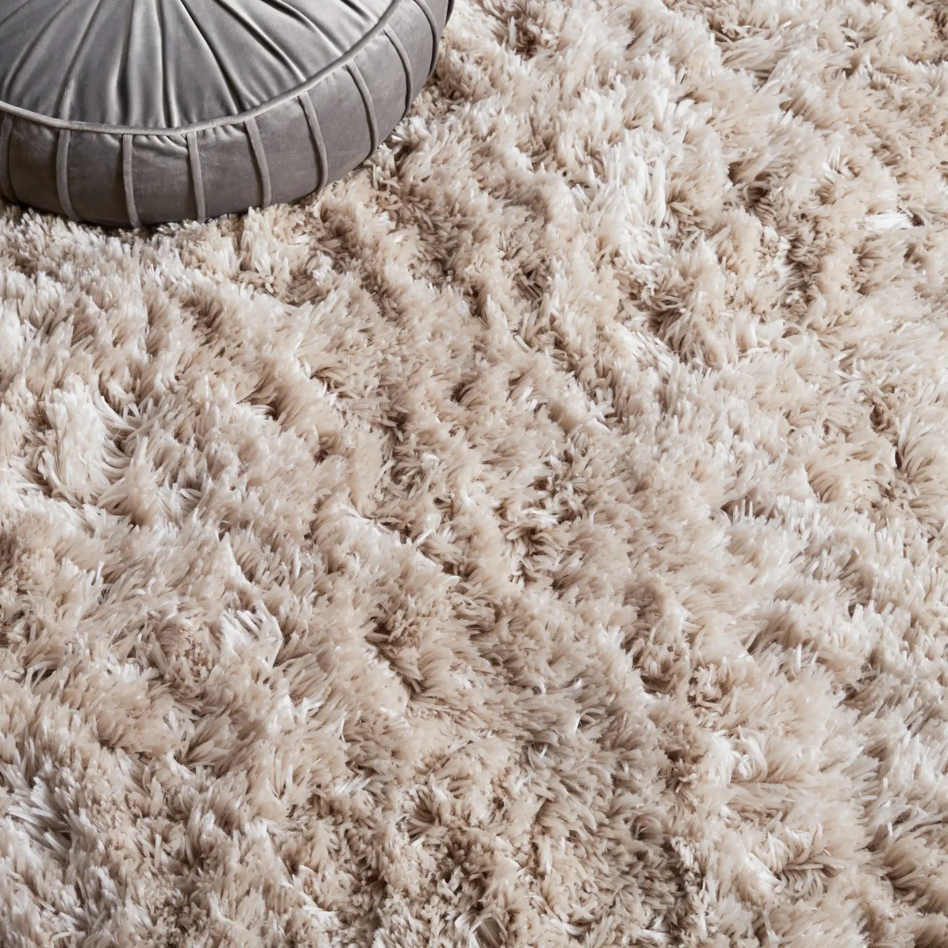 Arctic Solid Hand-Tufted Shag Rug in Light Beige in a styled room