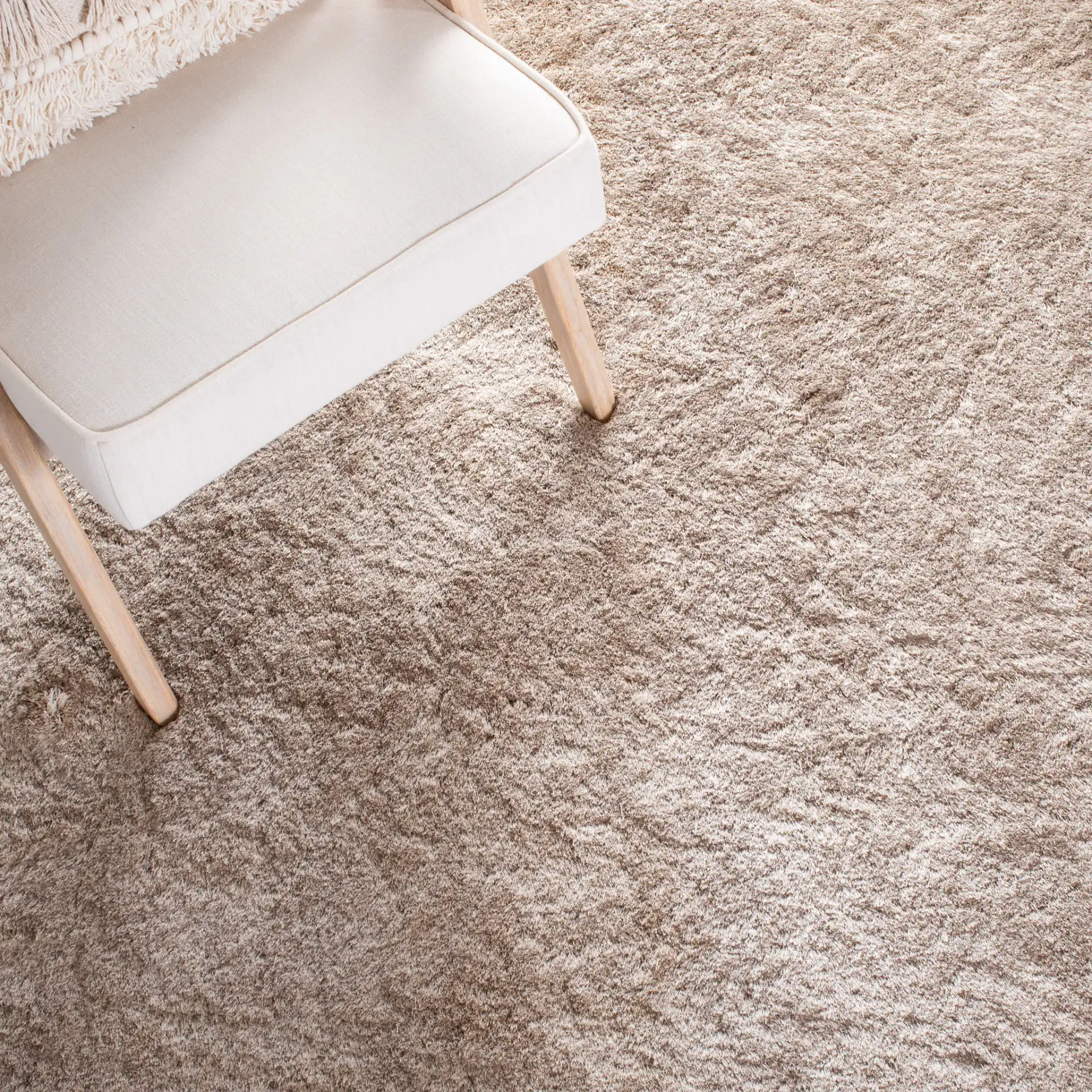 Paris Solid Hand-Tufted Shag Rug in Dark Beige in a styled room