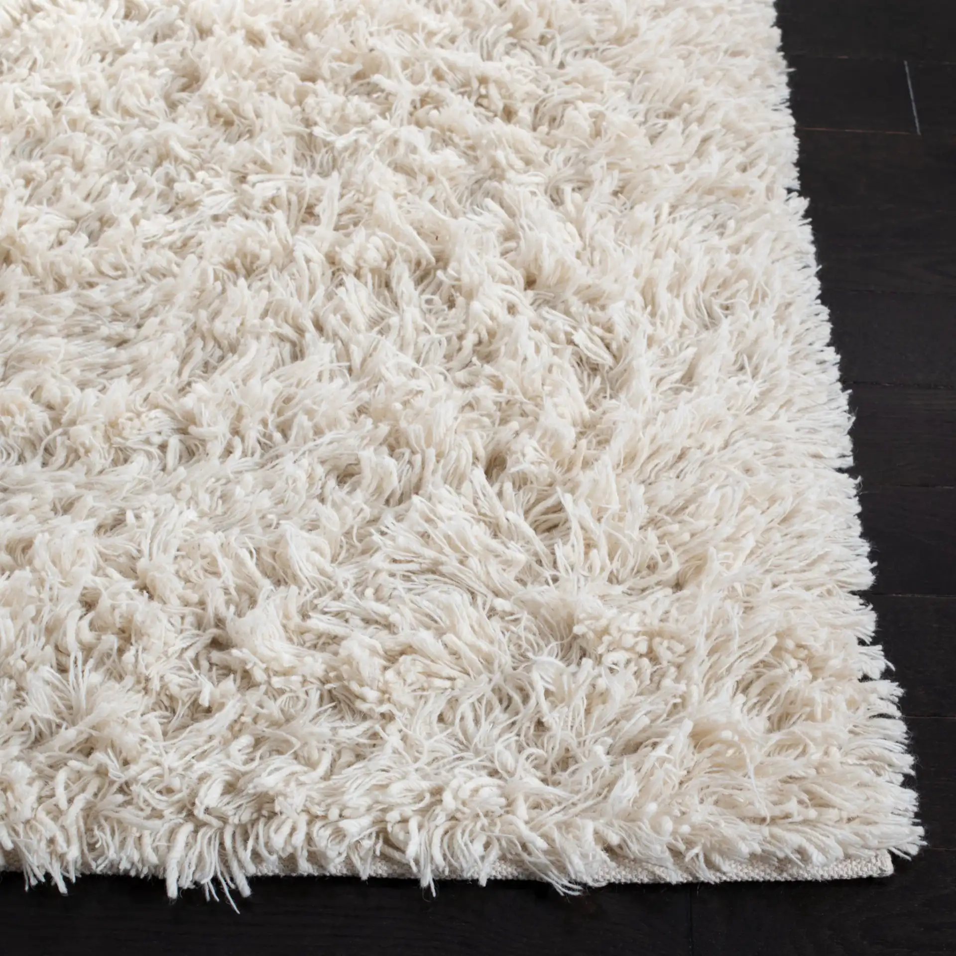 Carmel Solid Hand-Woven Wool Shag Rug in Ivory in a styled room