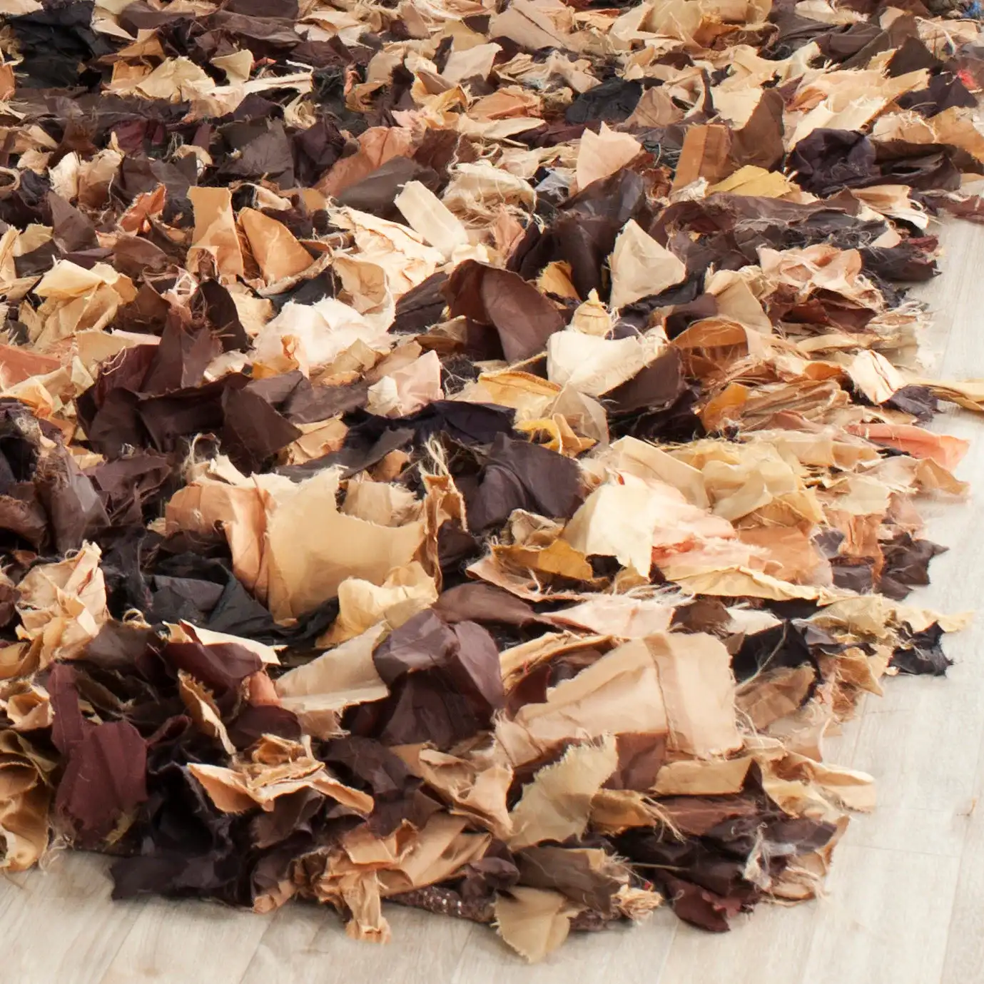 Rio Textured Solid Hand-Woven Shag Rug in Brown / Multicolor in a styled room