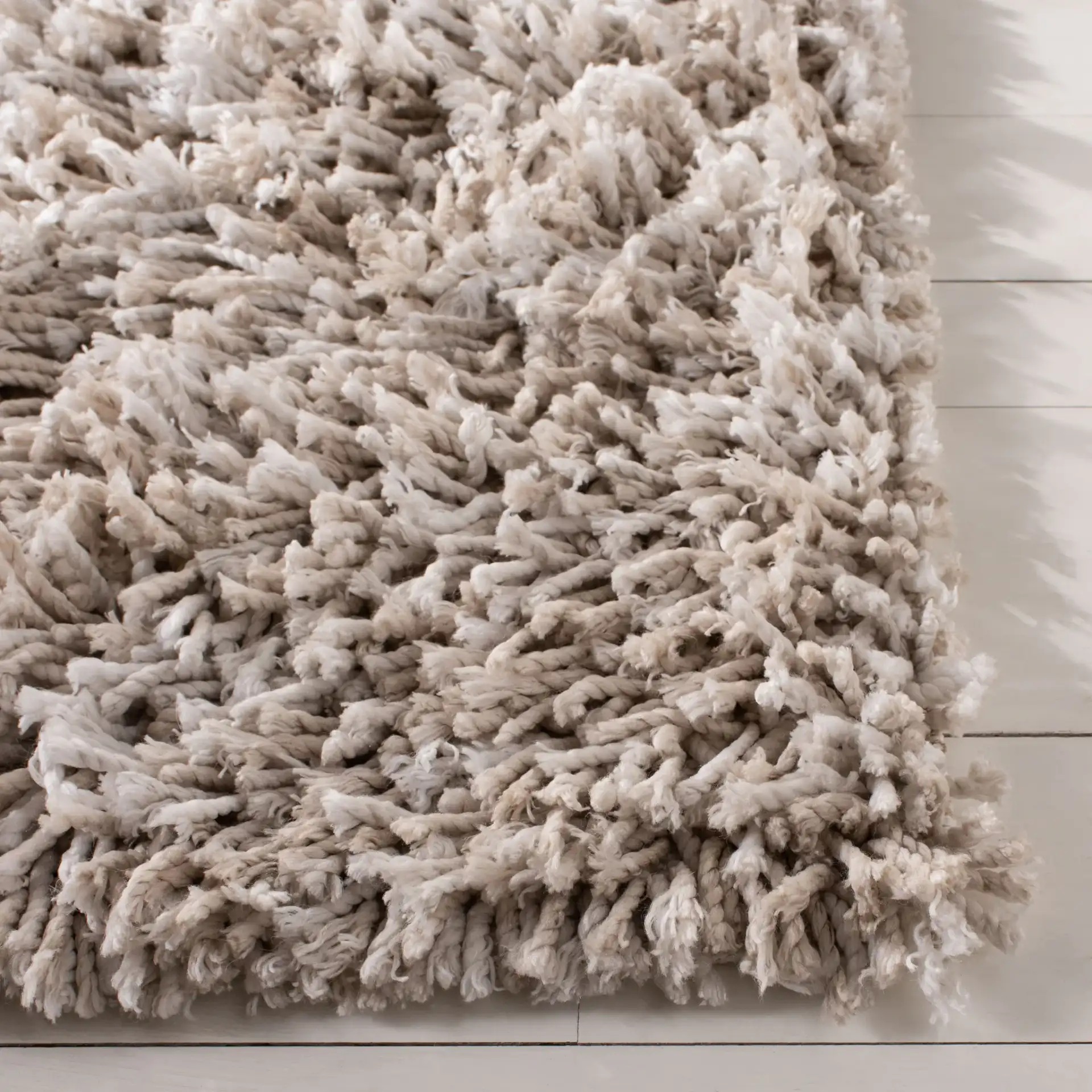 Rio Solid Hand-Loomed Shag Rug in Beige / Ivory in a styled room