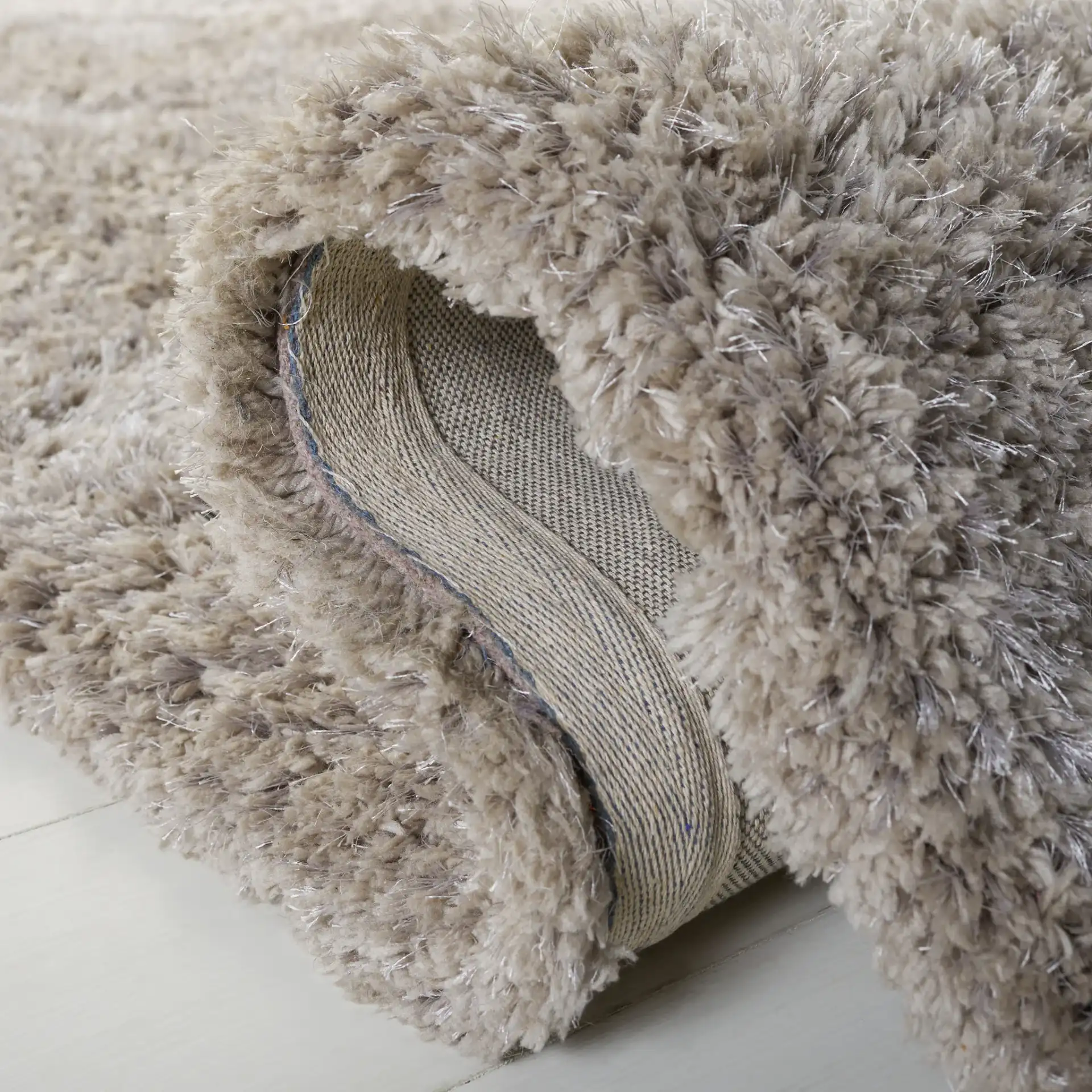 Florence Solid Hand-Tufted Shag Rug in Silver in a styled room