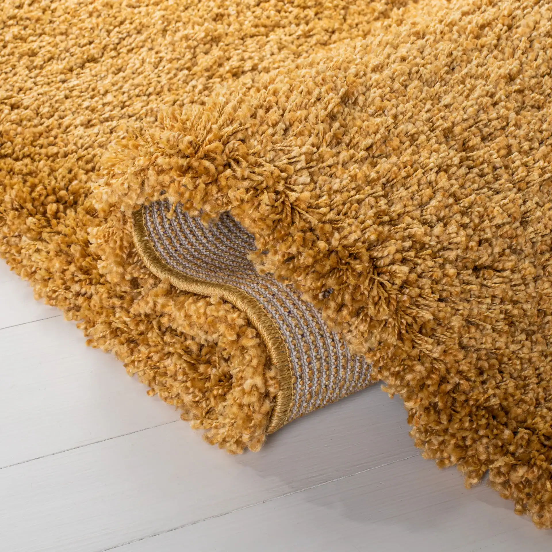 Hudson Solid Shag Rug in Gold in a styled room