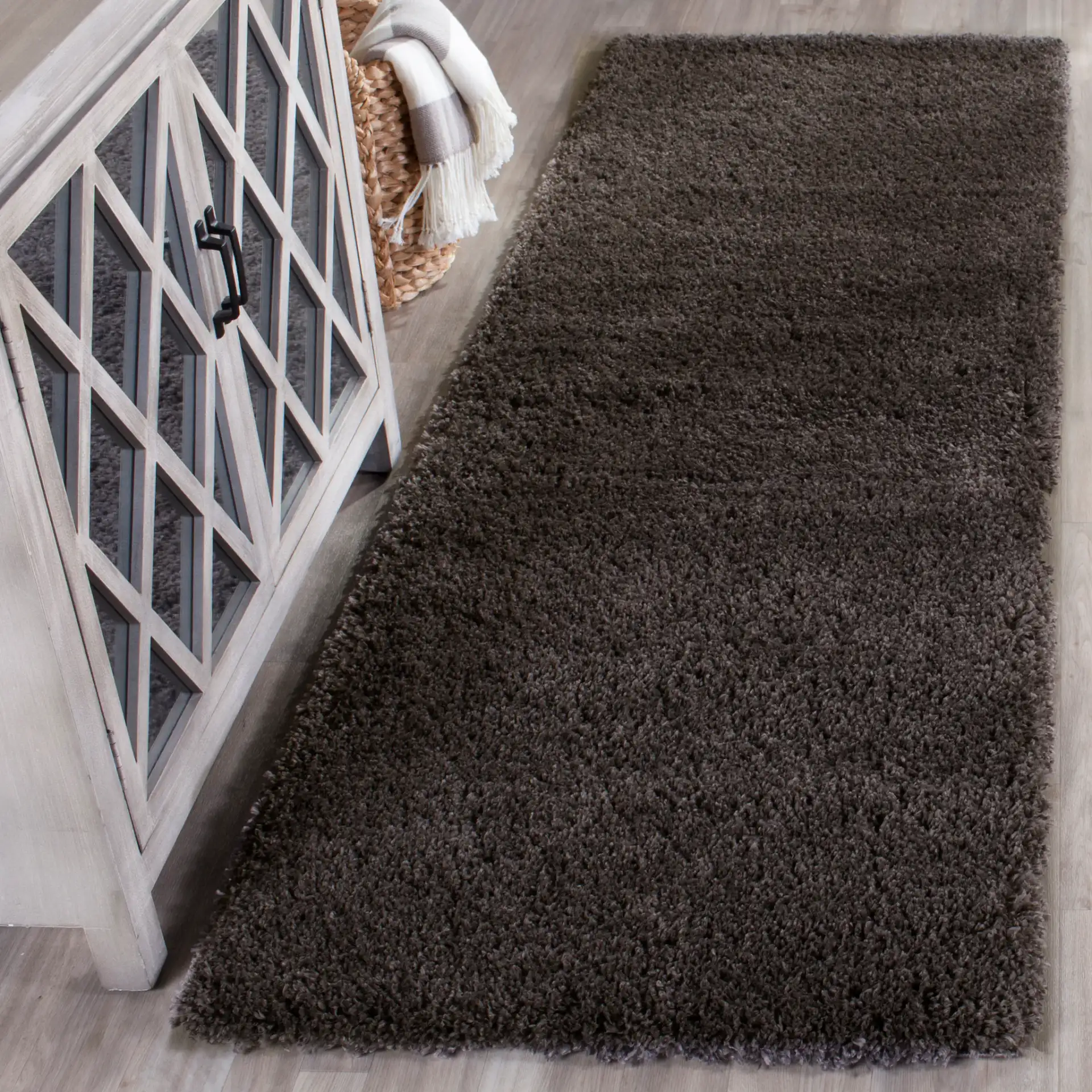 Reno Solid Shag Rug in Dark Gray in a styled room