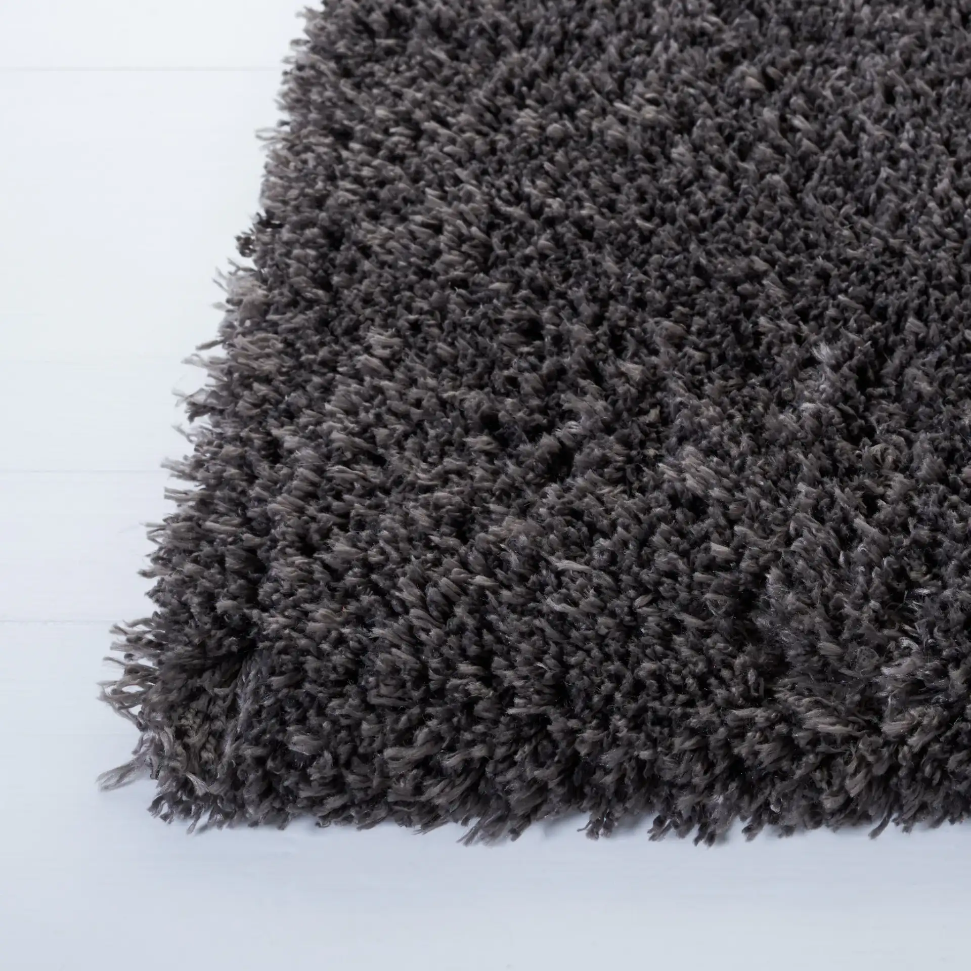 Reno Solid Shag Rug in Dark Gray in a styled room