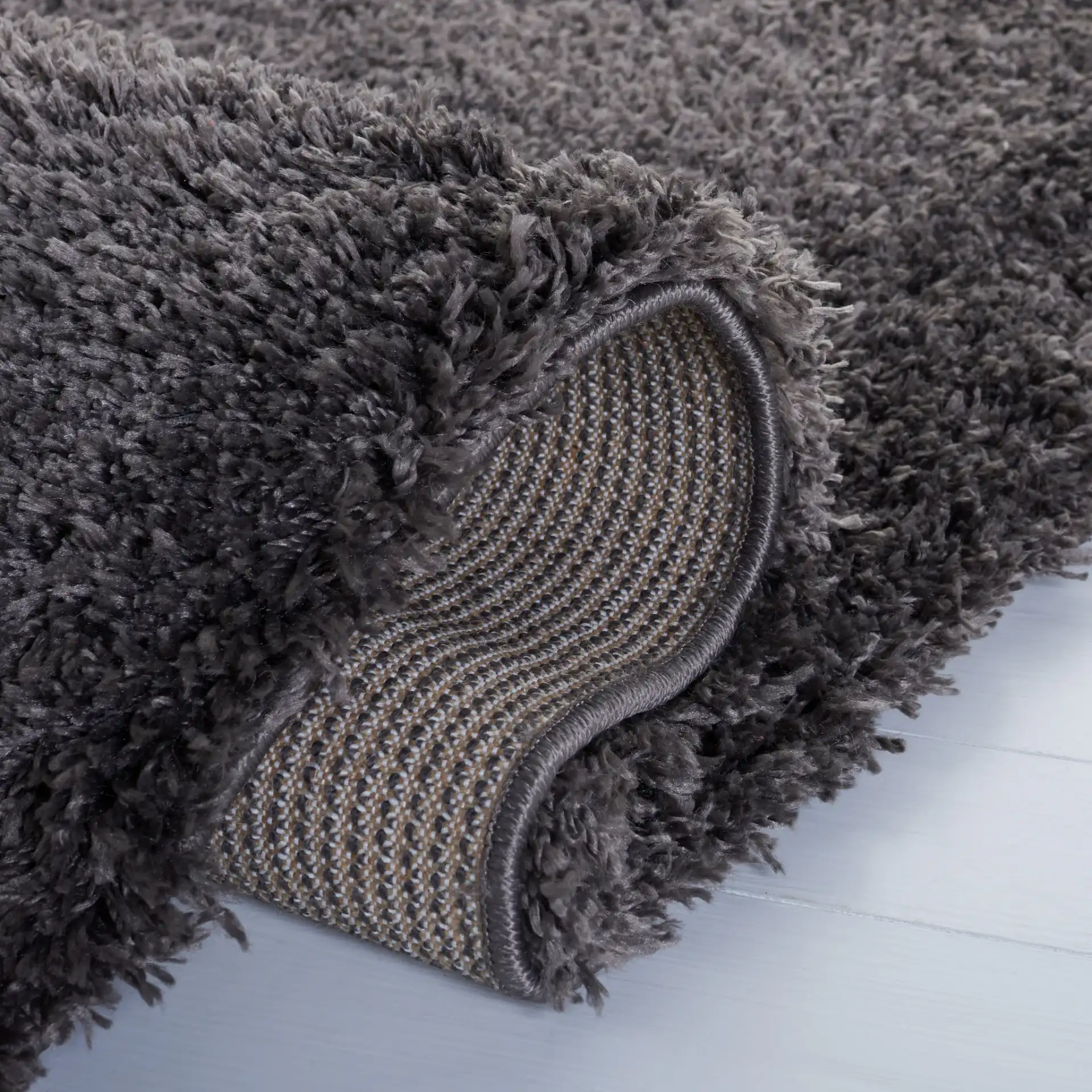 Reno Solid Shag Rug in Dark Gray in a styled room