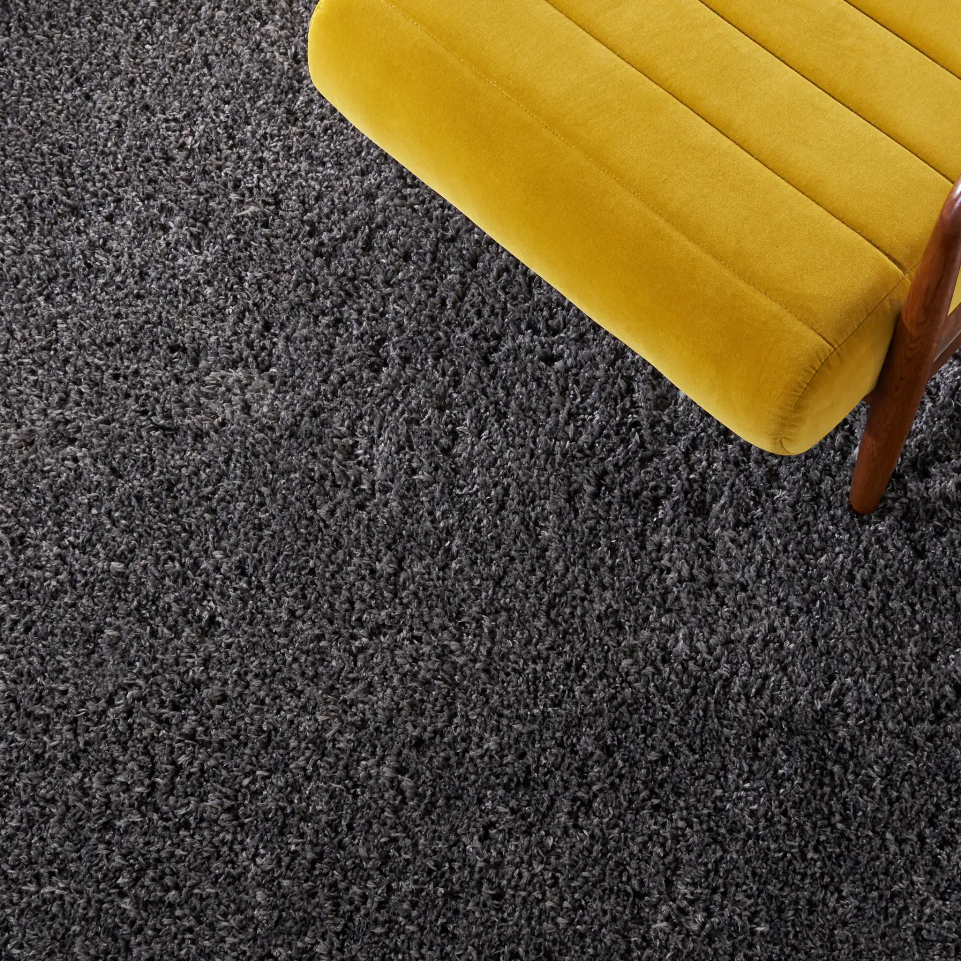 Reno Solid Shag Rug in Dark Gray in a styled room
