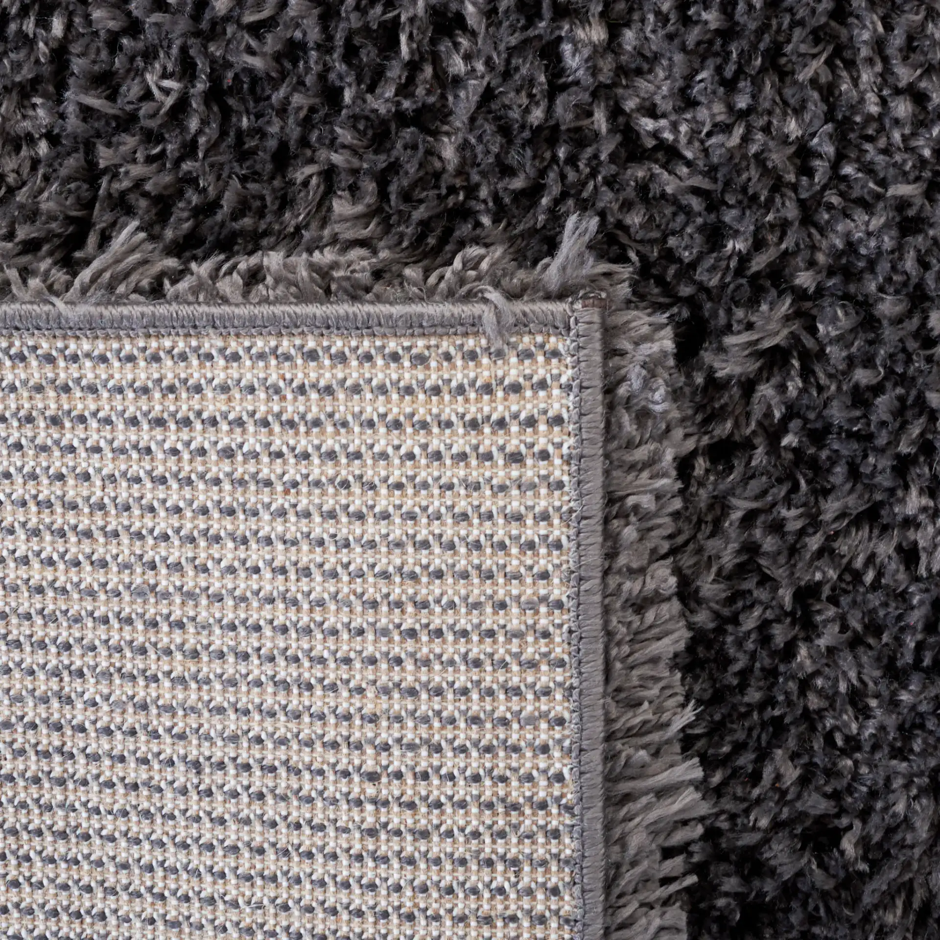 Reno Solid Shag Rug in Dark Gray in a styled room