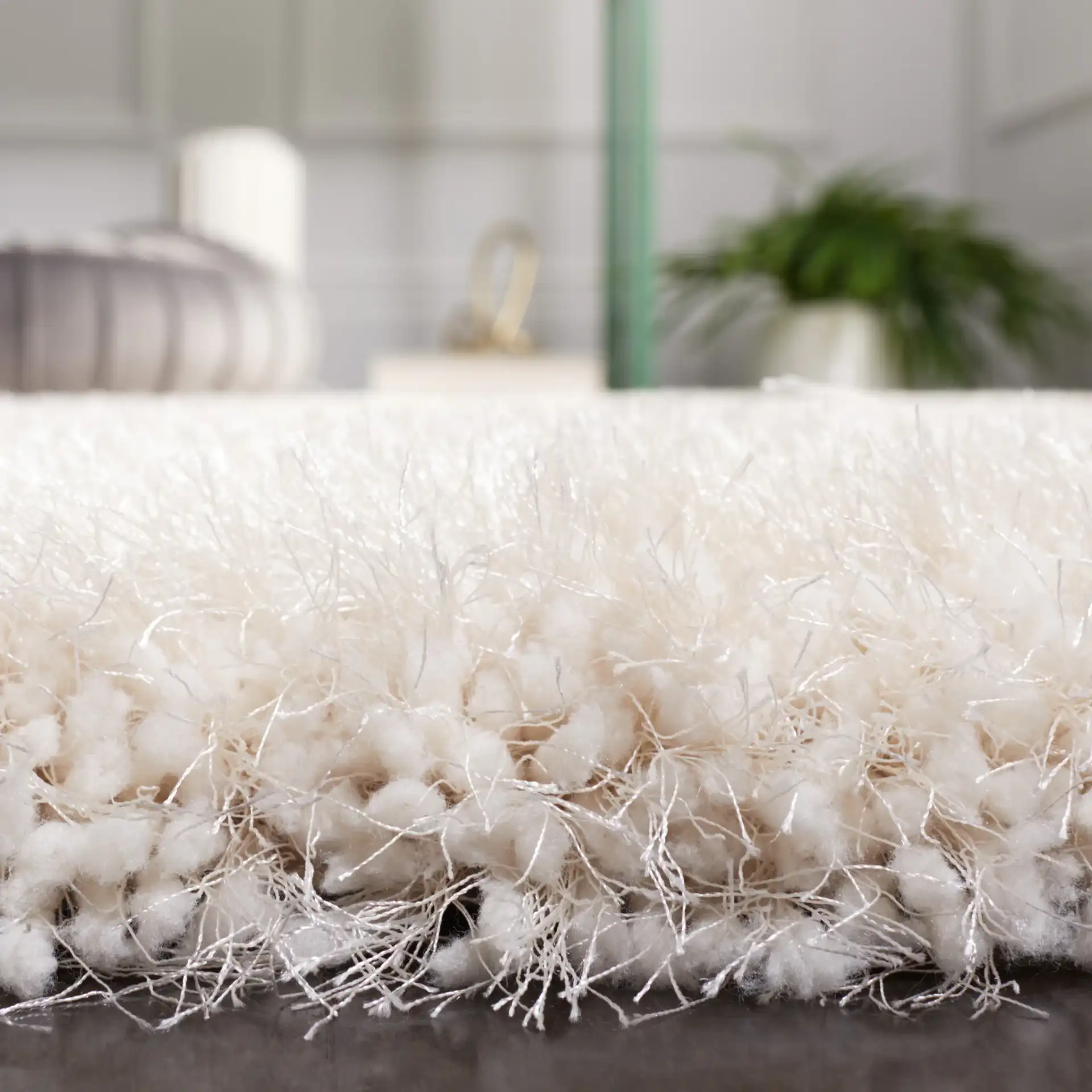 Luxe Solid Hand-Tufted Shag Rug in Bone in a styled room