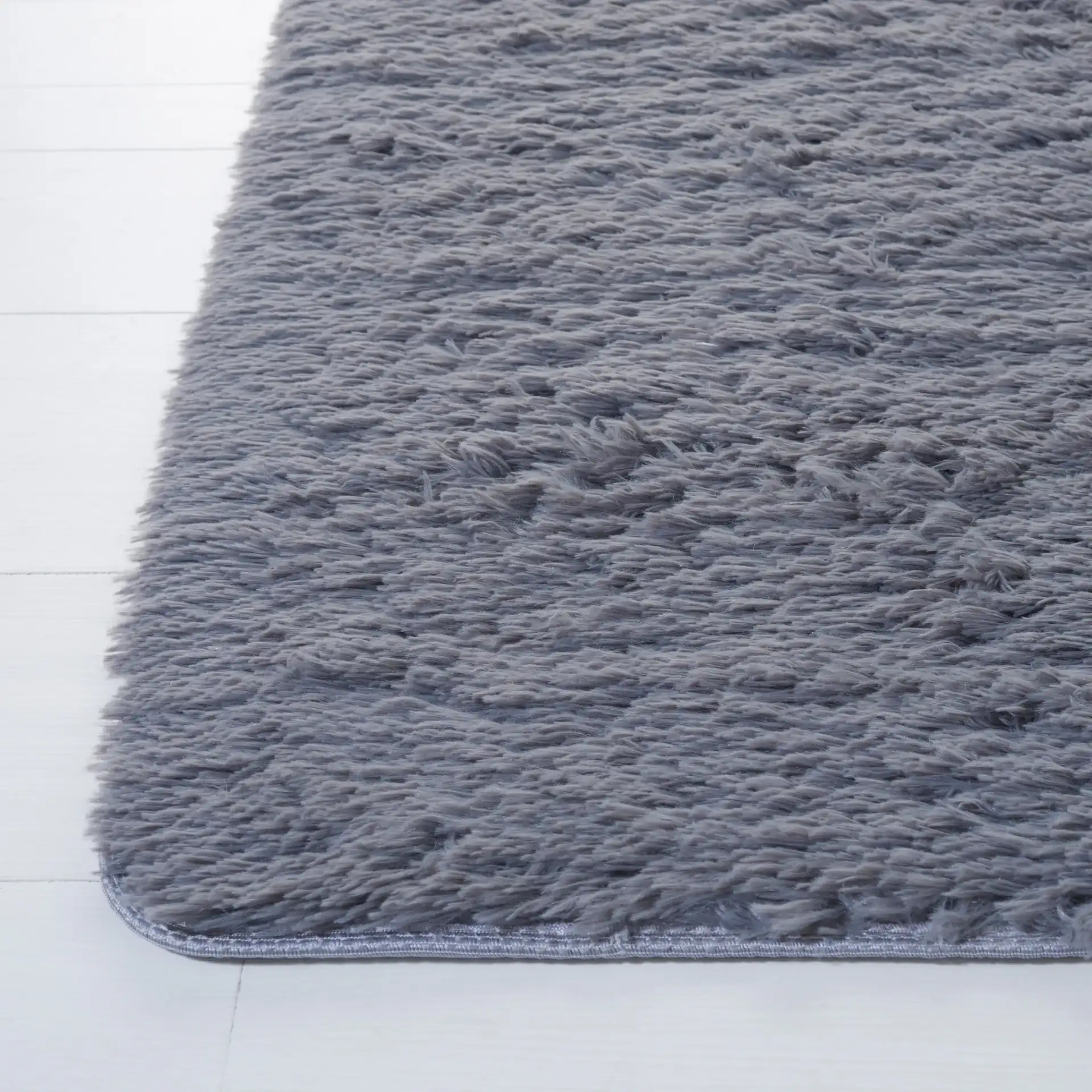 Soho Solid Washable Shag Rug in Dark Gray in a styled room
