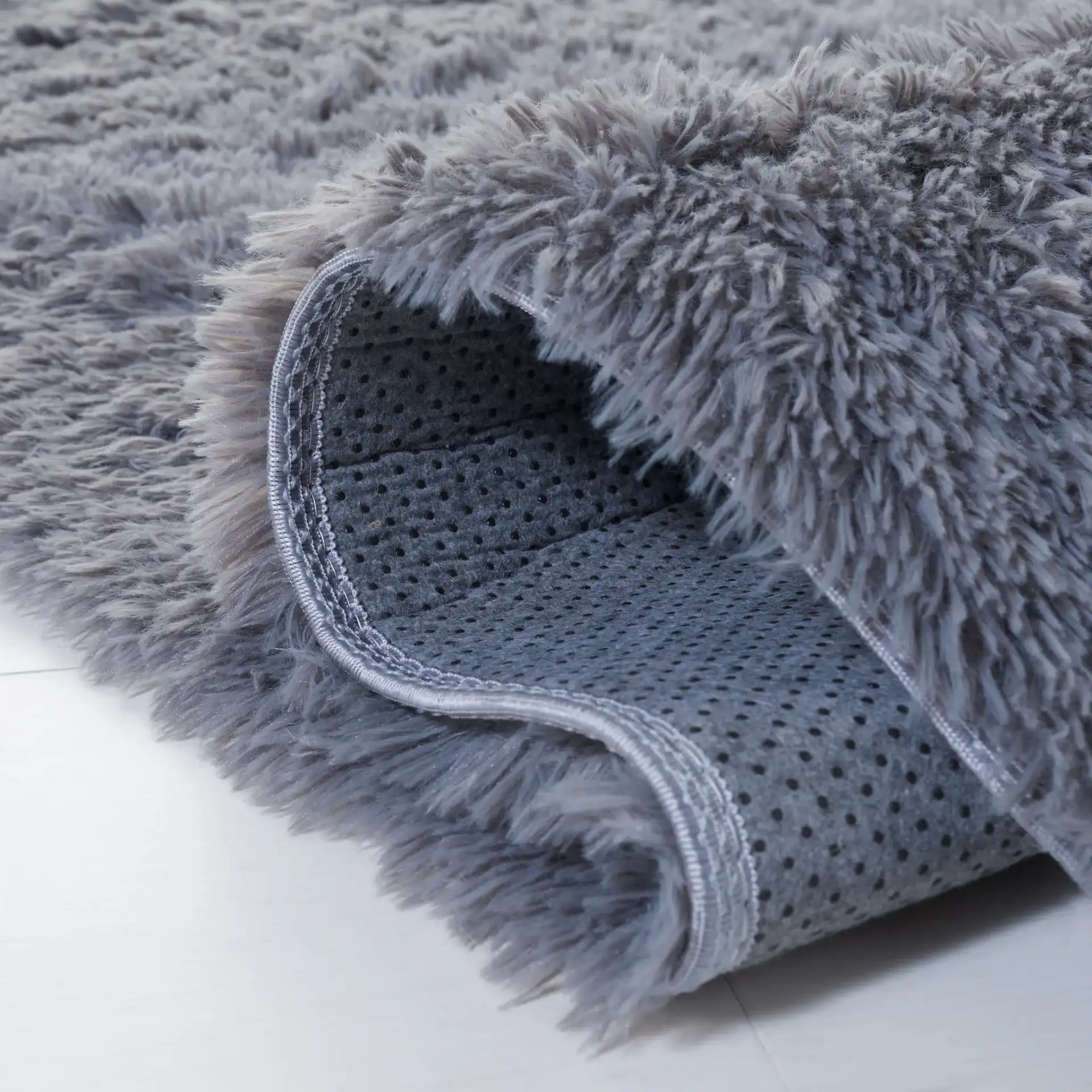 Soho Solid Washable Shag Rug in Dark Gray in a styled room
