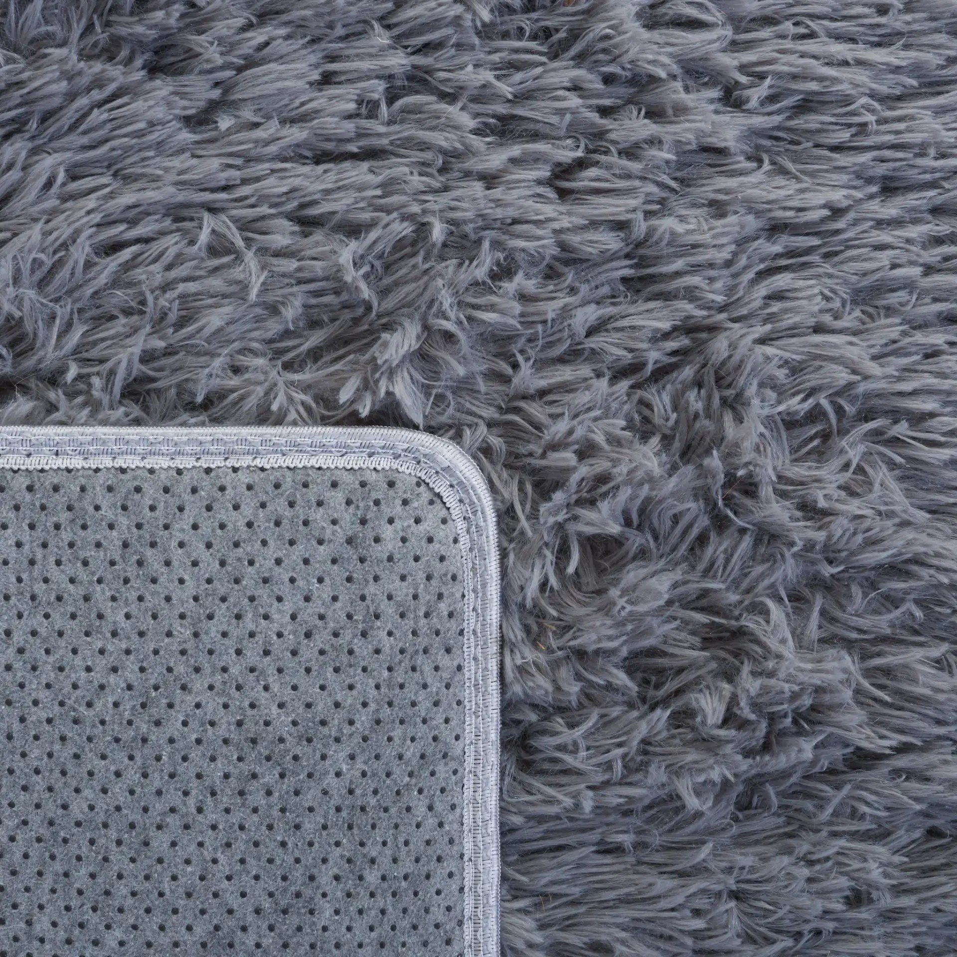 Soho Solid Washable Shag Rug in Dark Gray in a styled room