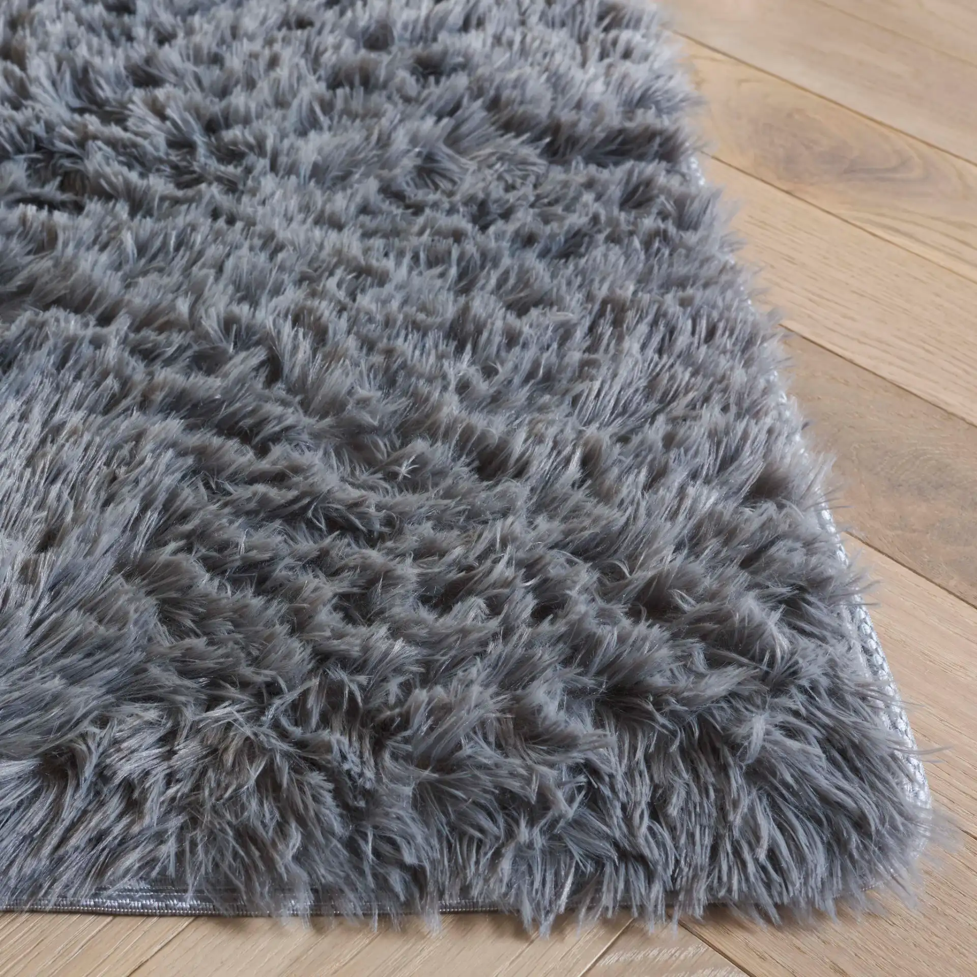 Soho Solid Washable Shag Rug in Dark Gray in a styled room