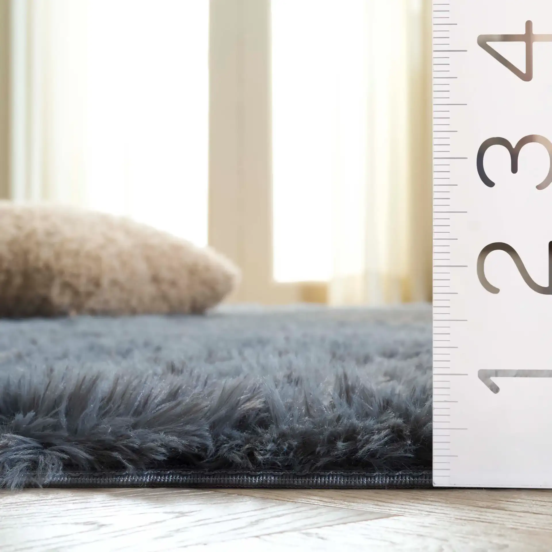 Soho Solid Washable Shag Rug in Dark Gray in a styled room