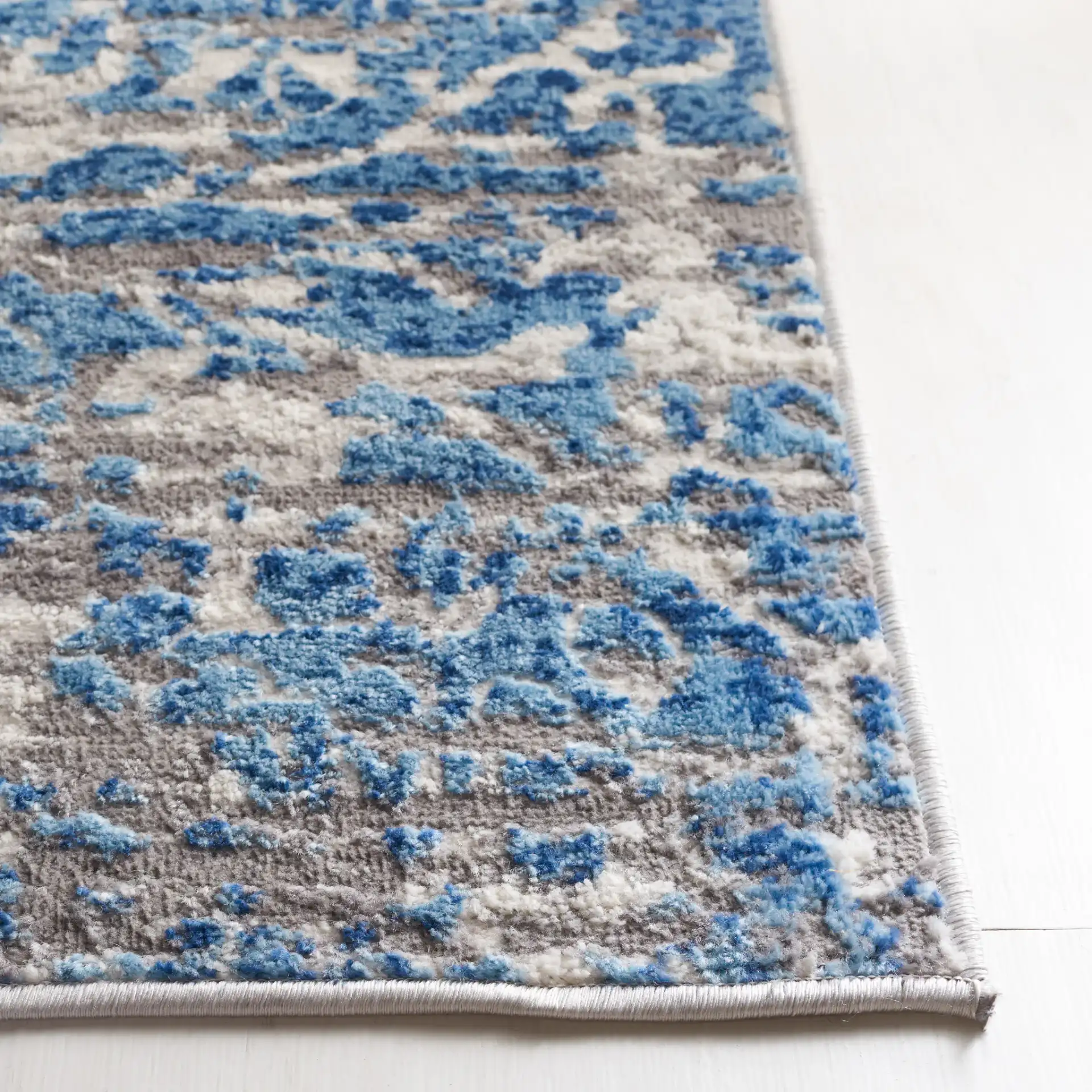 Shivan Distressed Damask Rug in Blue / Ivory in a styled room