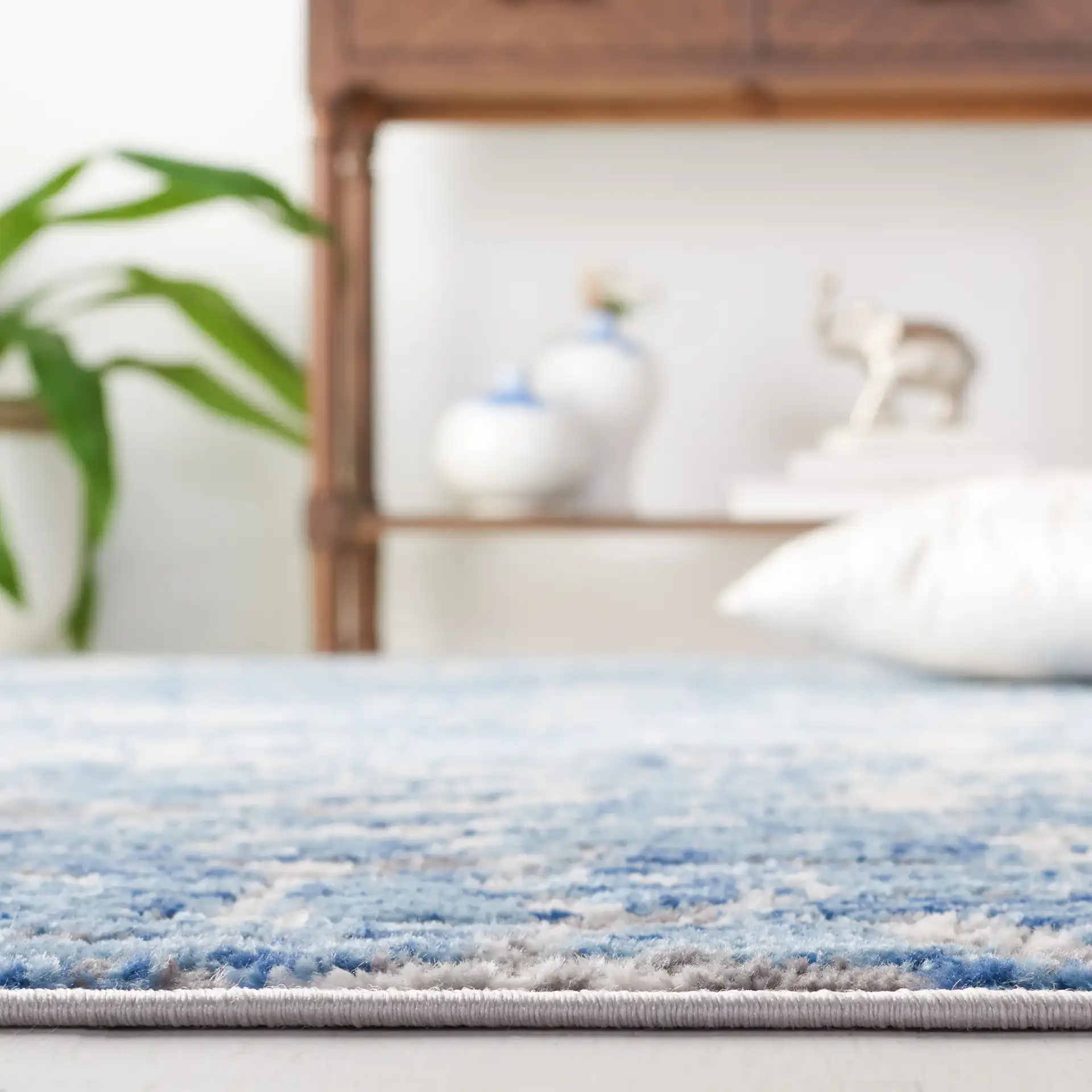 Shivan Distressed Damask Rug in Blue / Ivory in a styled room