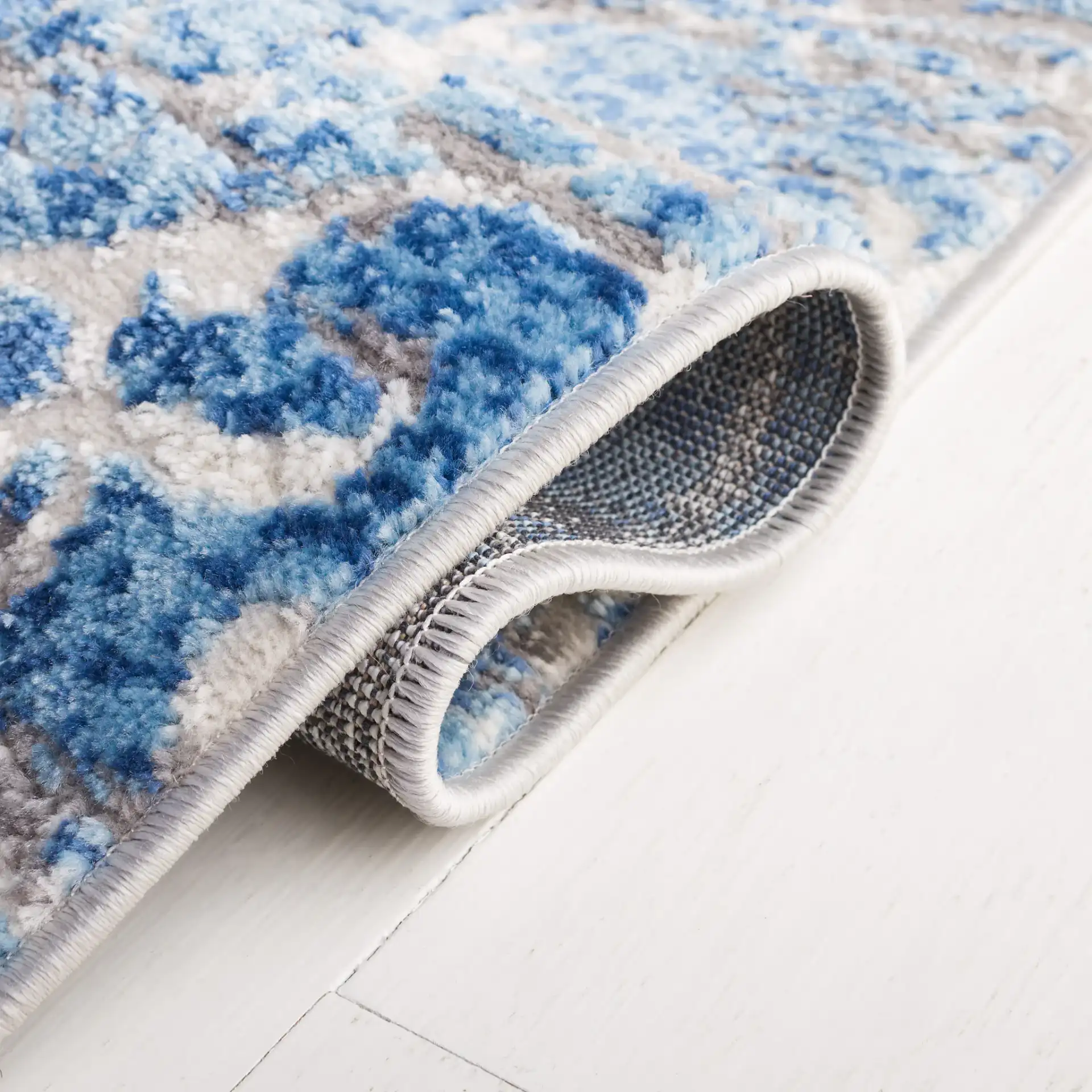 Shivan Distressed Damask Rug in Blue / Ivory in a styled room