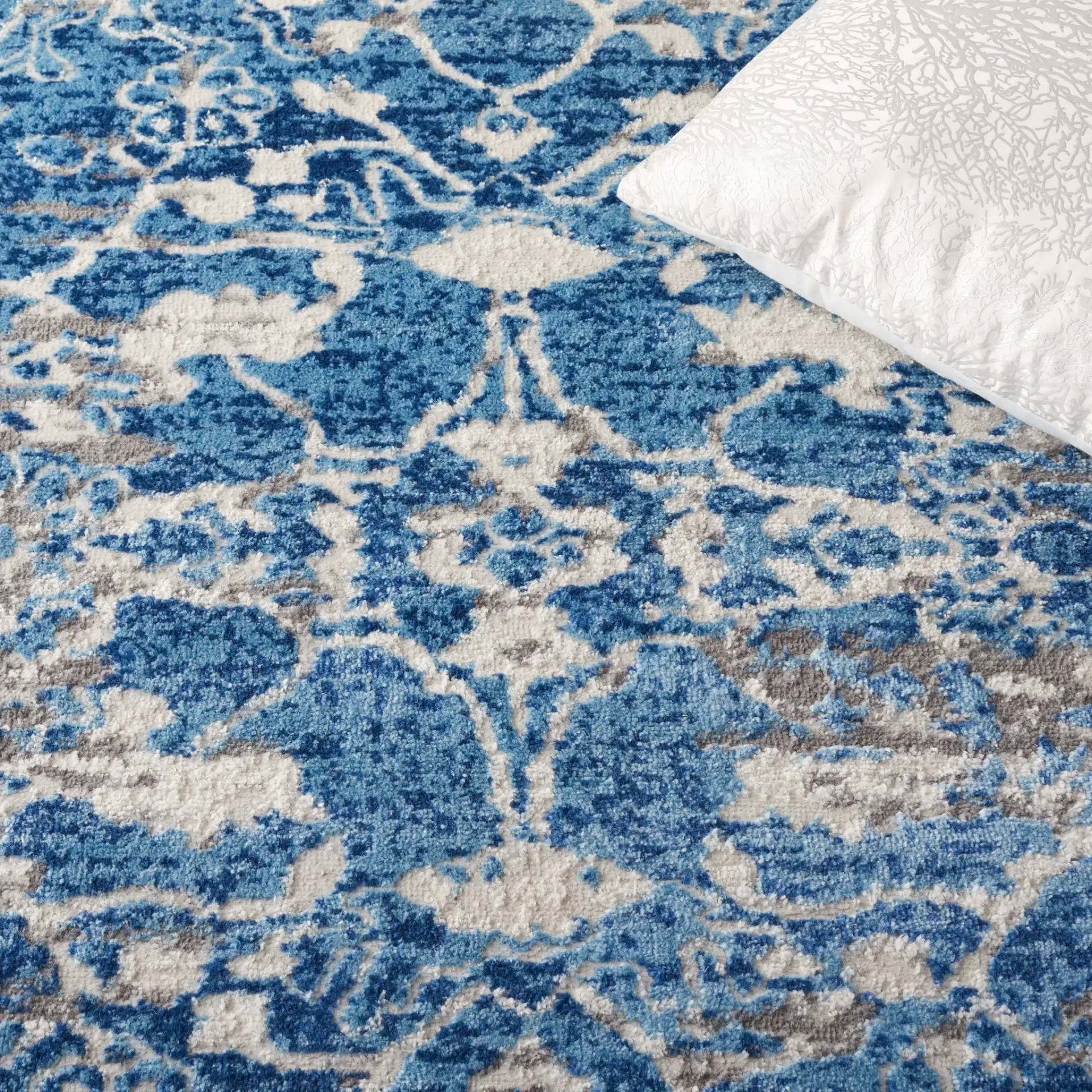 Shivan Distressed Damask Rug in Blue / Ivory in a styled room