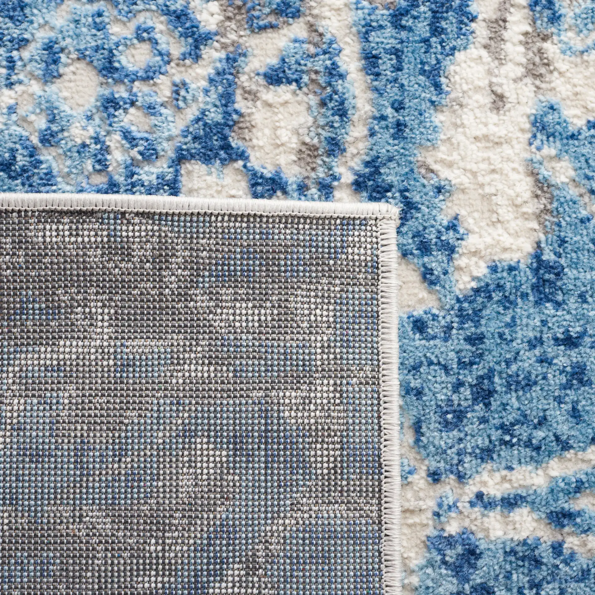 Shivan Distressed Damask Rug in Blue / Ivory in a styled room