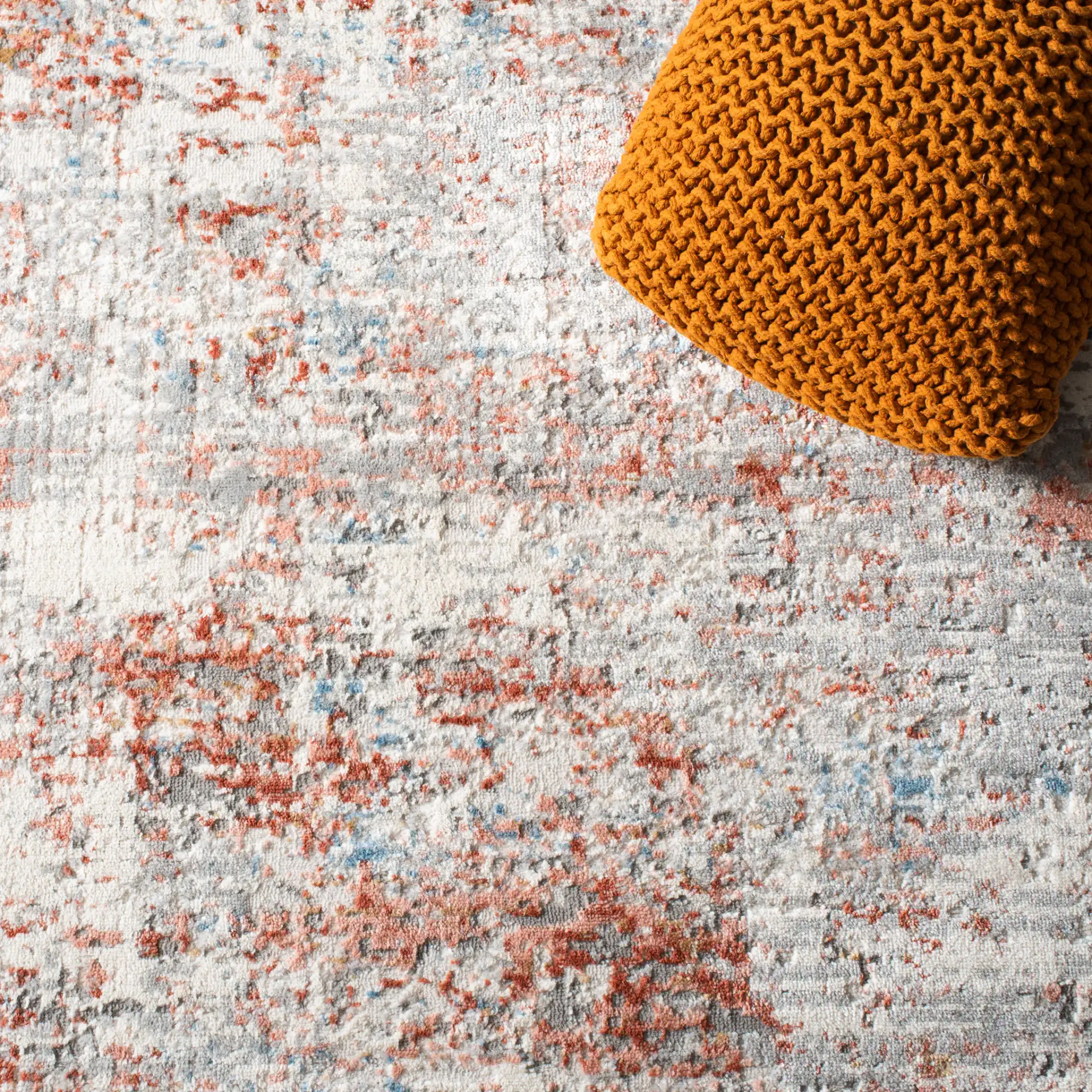 Shivan Abstract Mottled Rug in Ivory / Rust in a styled room