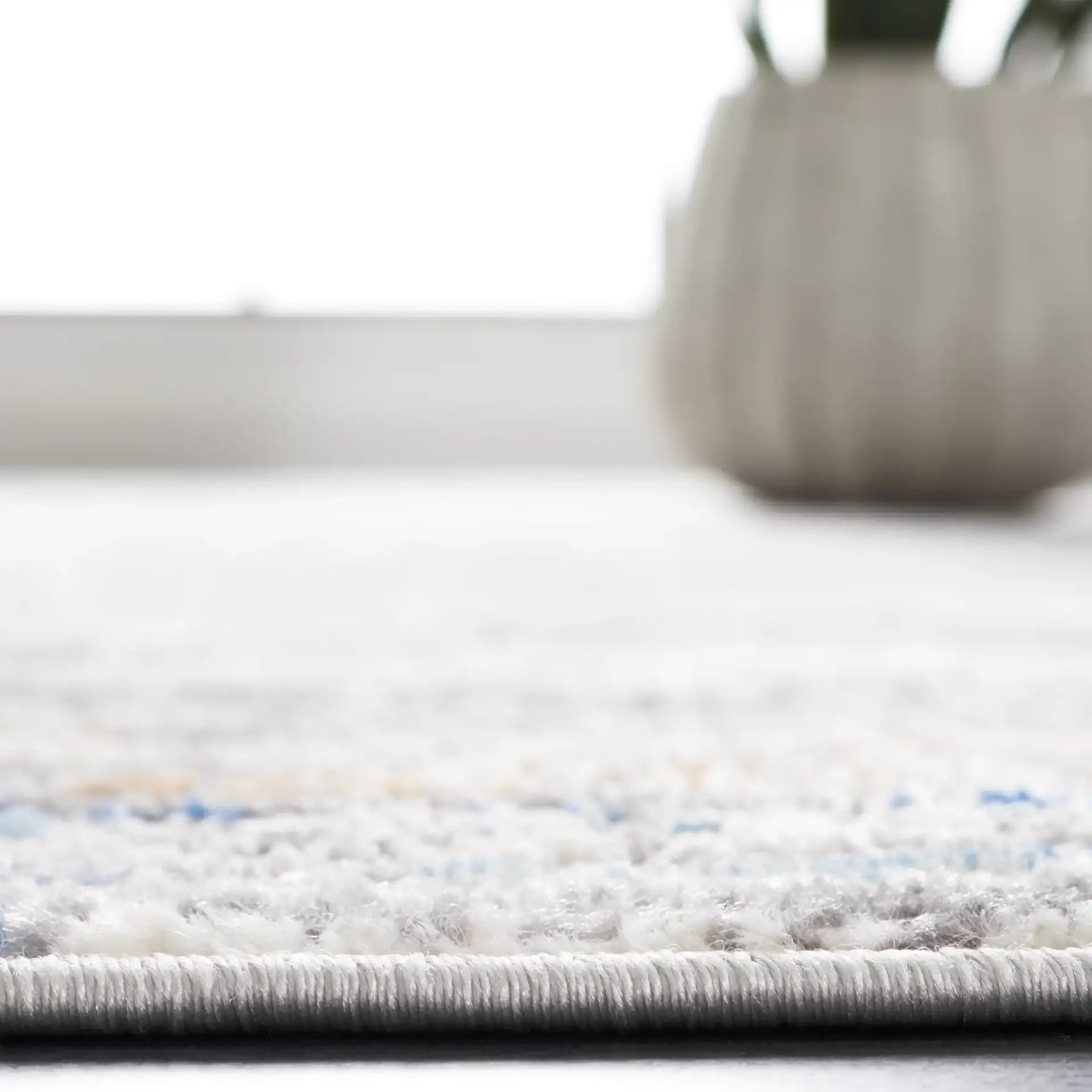 Shivan Abstract Striations Rug in Light Gray / Blue in a styled room