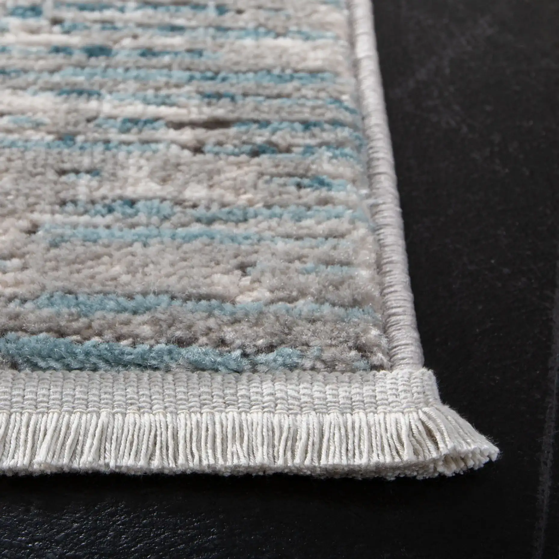 Shivan Striated Abstract Rug in Blue / Gray in a styled room