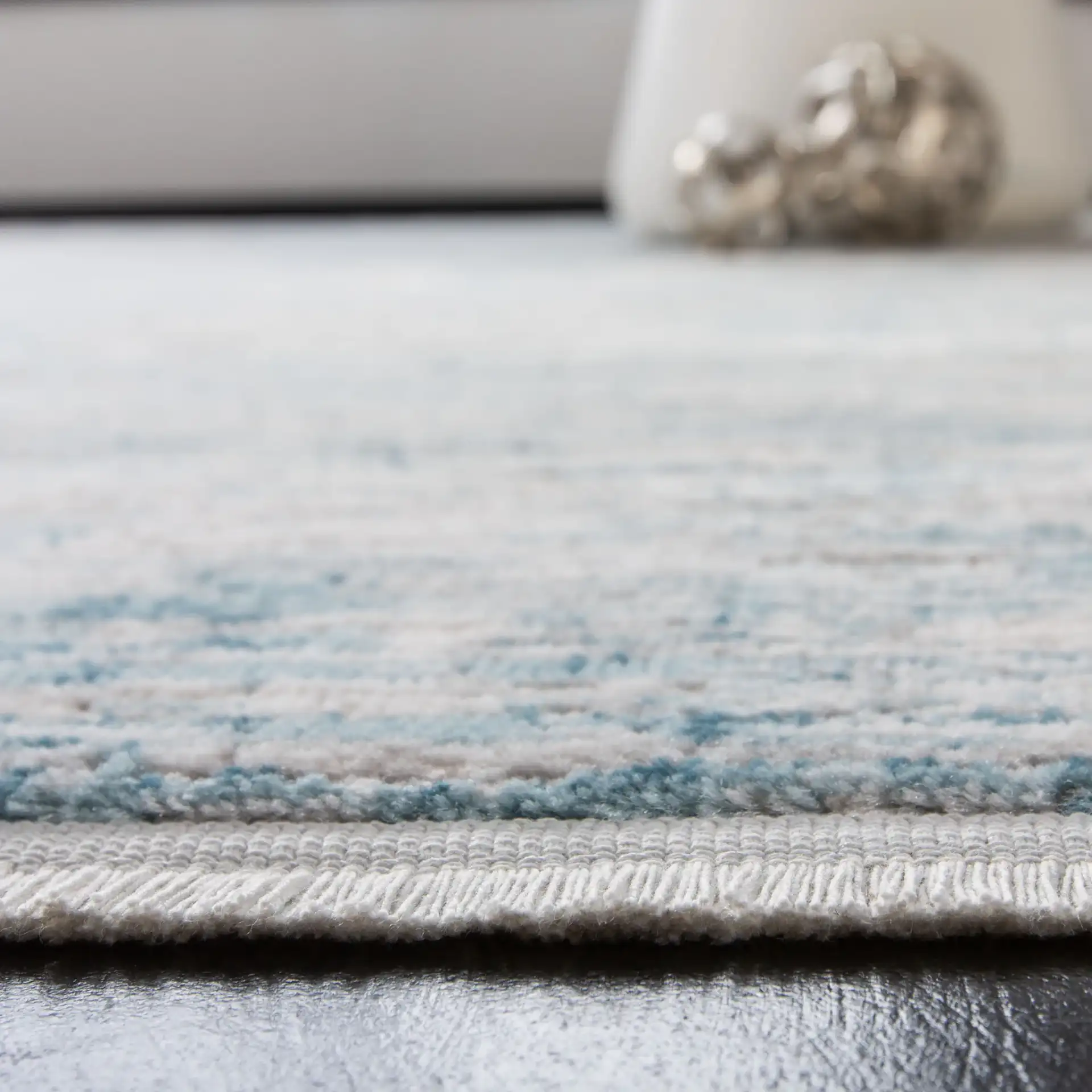 Shivan Striated Abstract Rug in Blue / Gray in a styled room