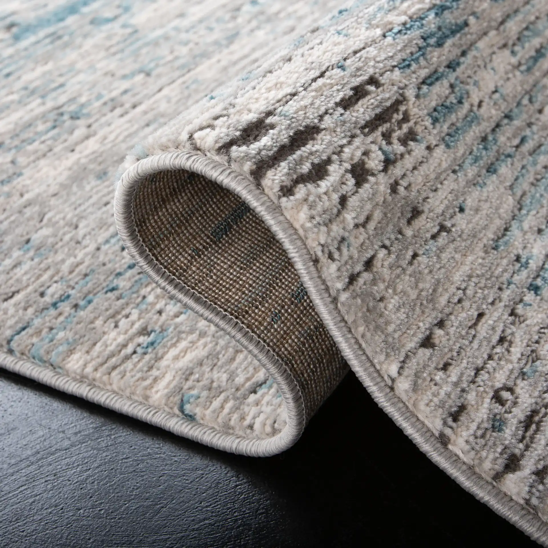 Shivan Striated Abstract Rug in Blue / Gray in a styled room