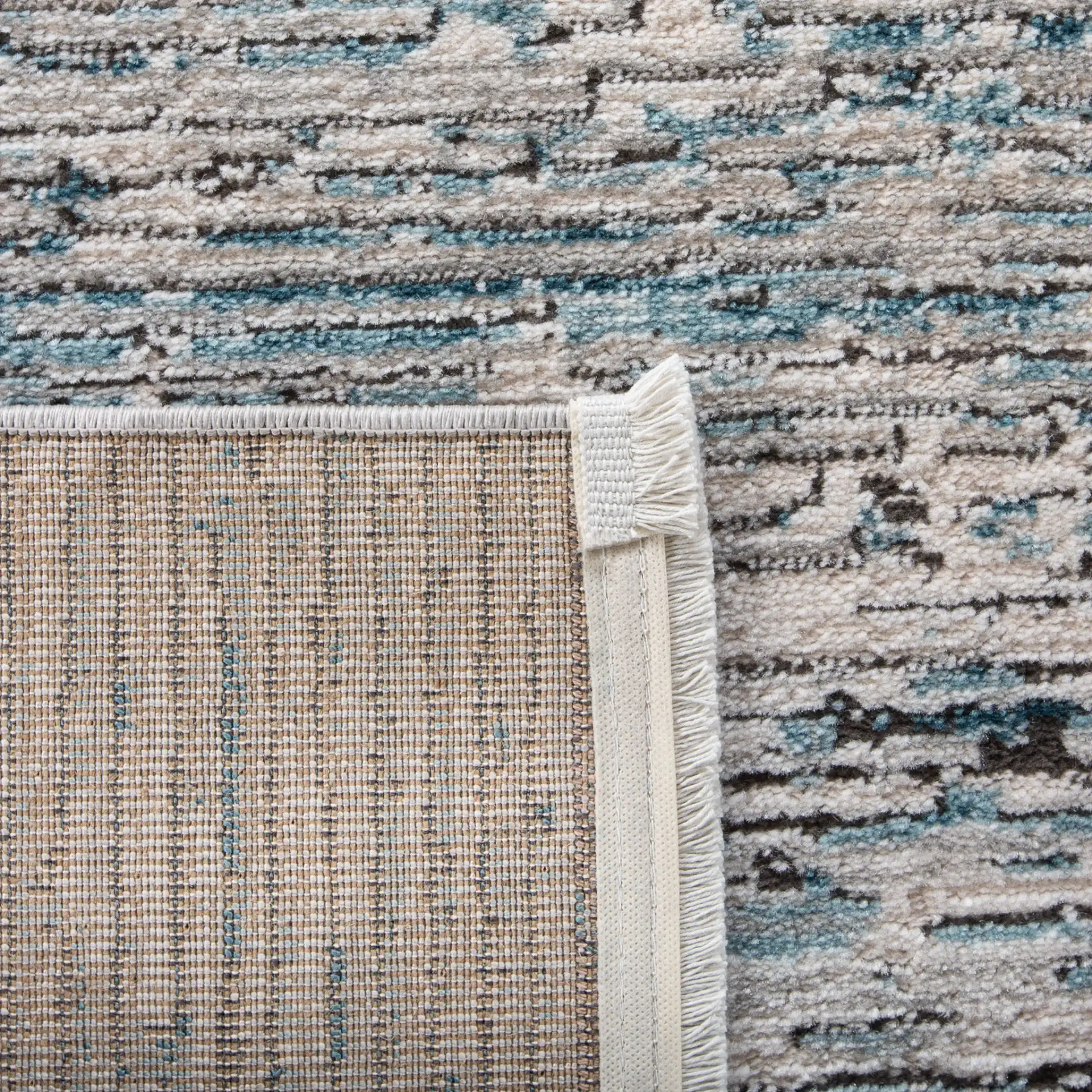 Shivan Striated Abstract Rug in Blue / Gray in a styled room