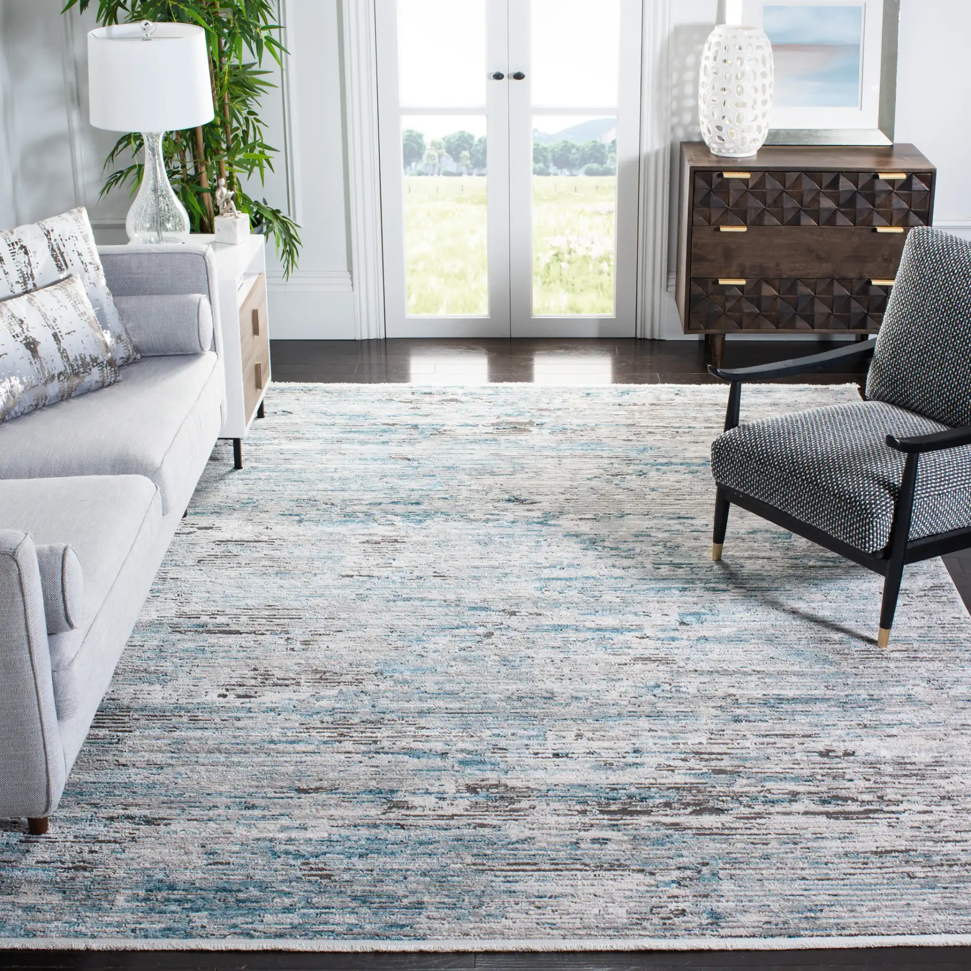 Shivan Striated Abstract Rug in Blue / Gray in a styled room