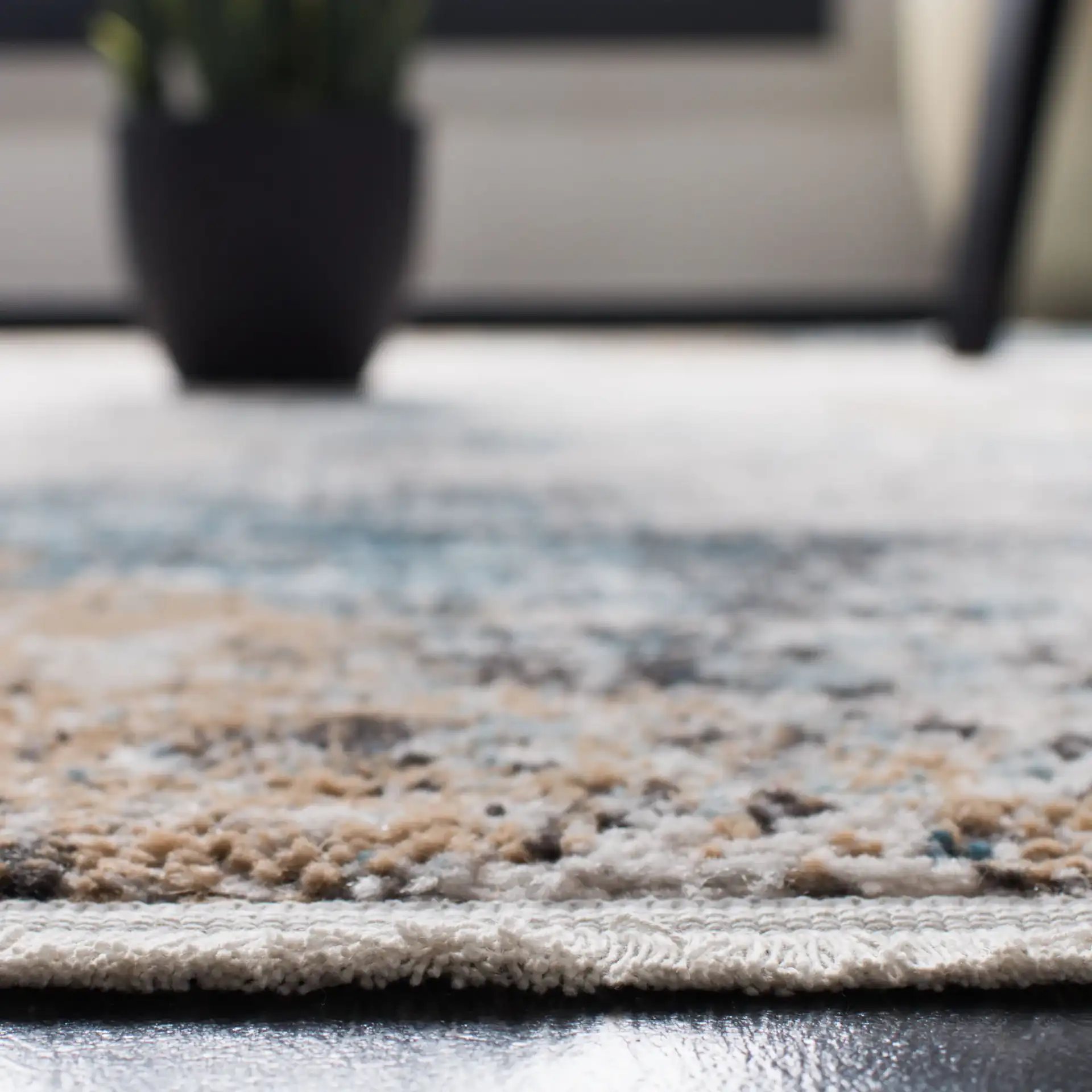 Shivan Abstract Distressed Rug in Ivory / Gray in a styled room