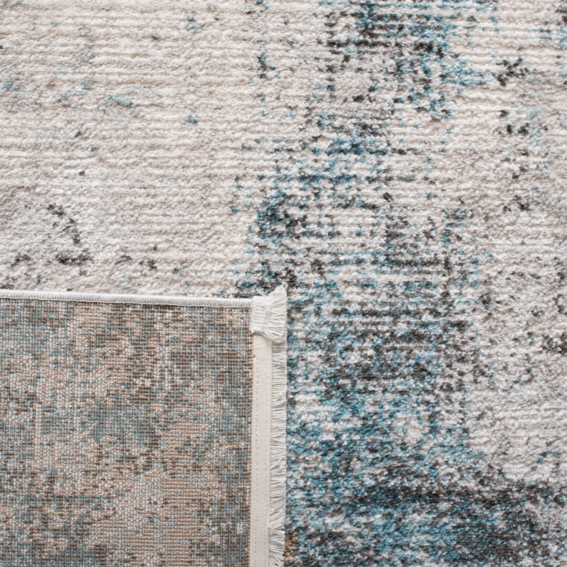 Shivan Abstract Distressed Rug in Ivory / Gray in a styled room