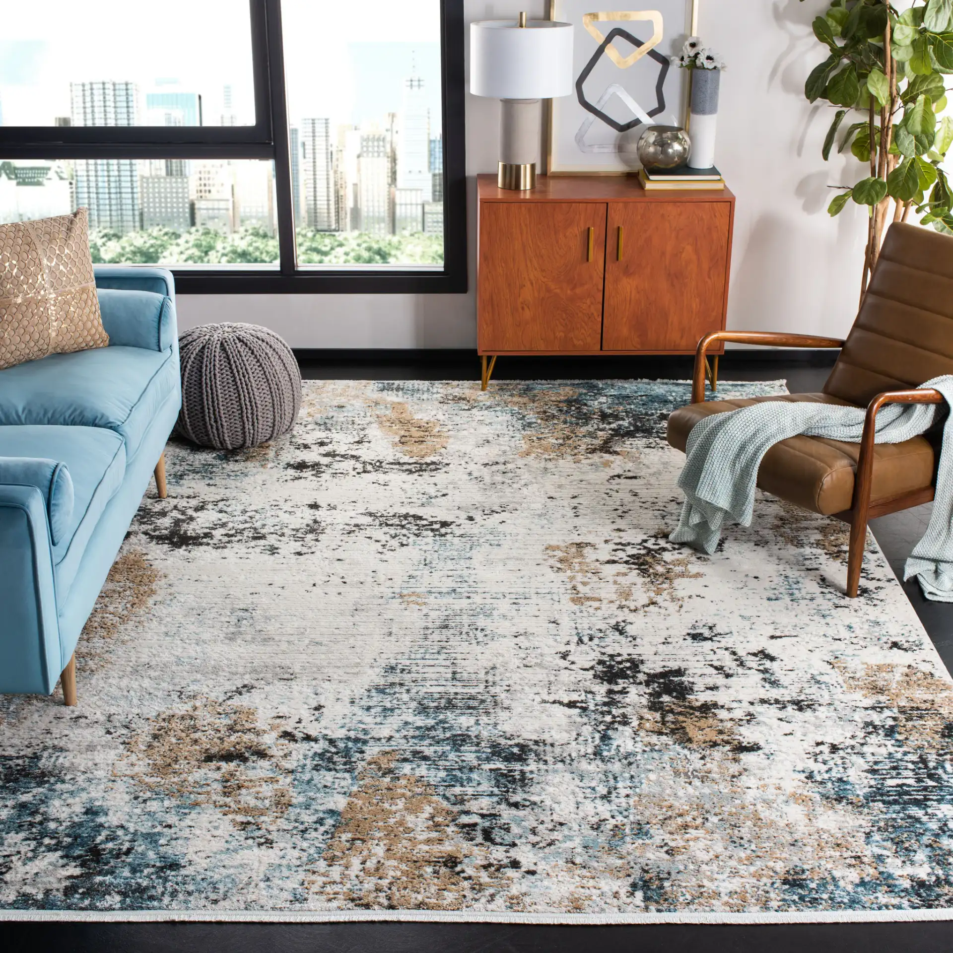 Shivan Abstract Distressed Rug in Ivory / Gray in a styled room